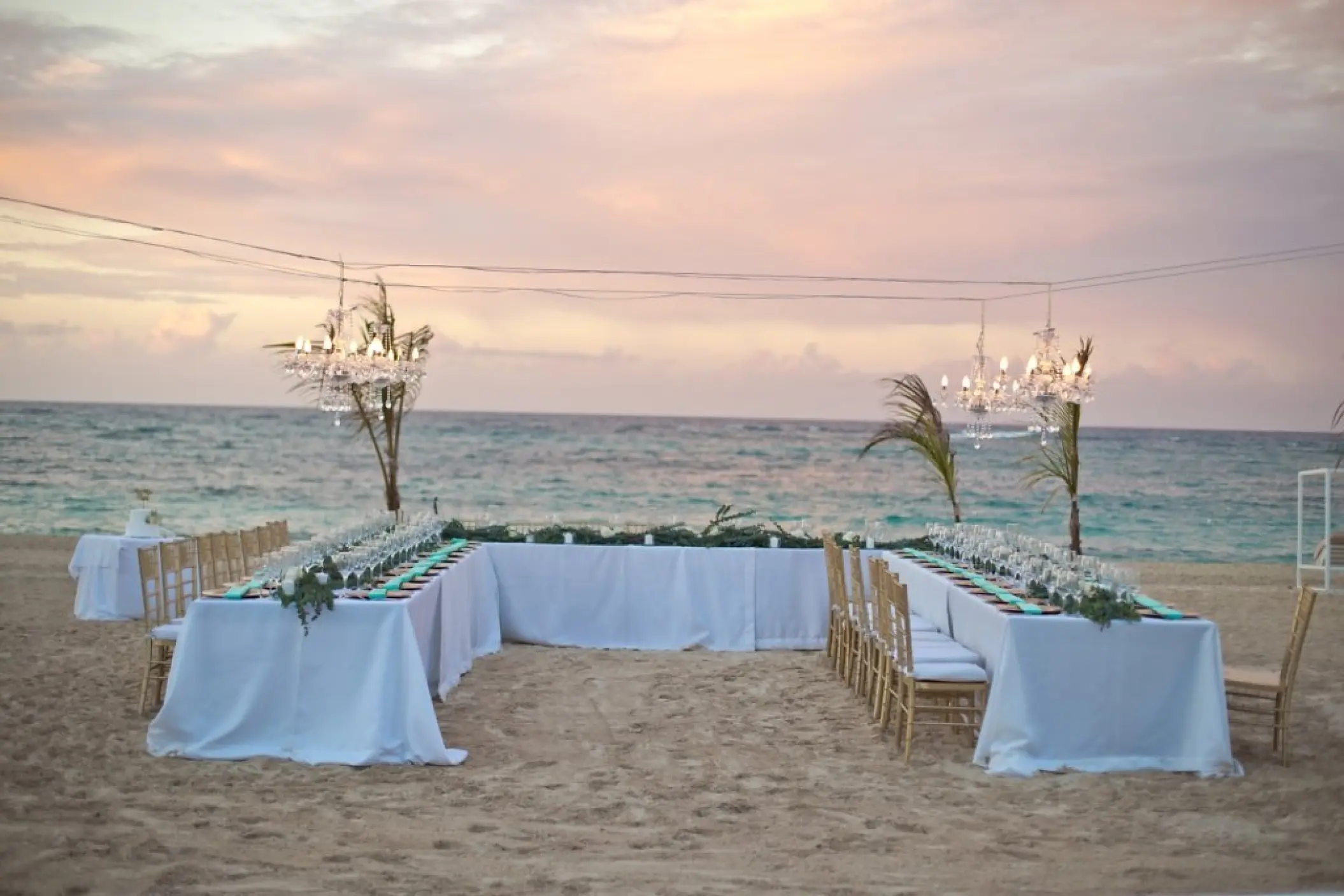 Beachfront wedding reception setup with chandeliers at Majestic Mirage Punta Cana