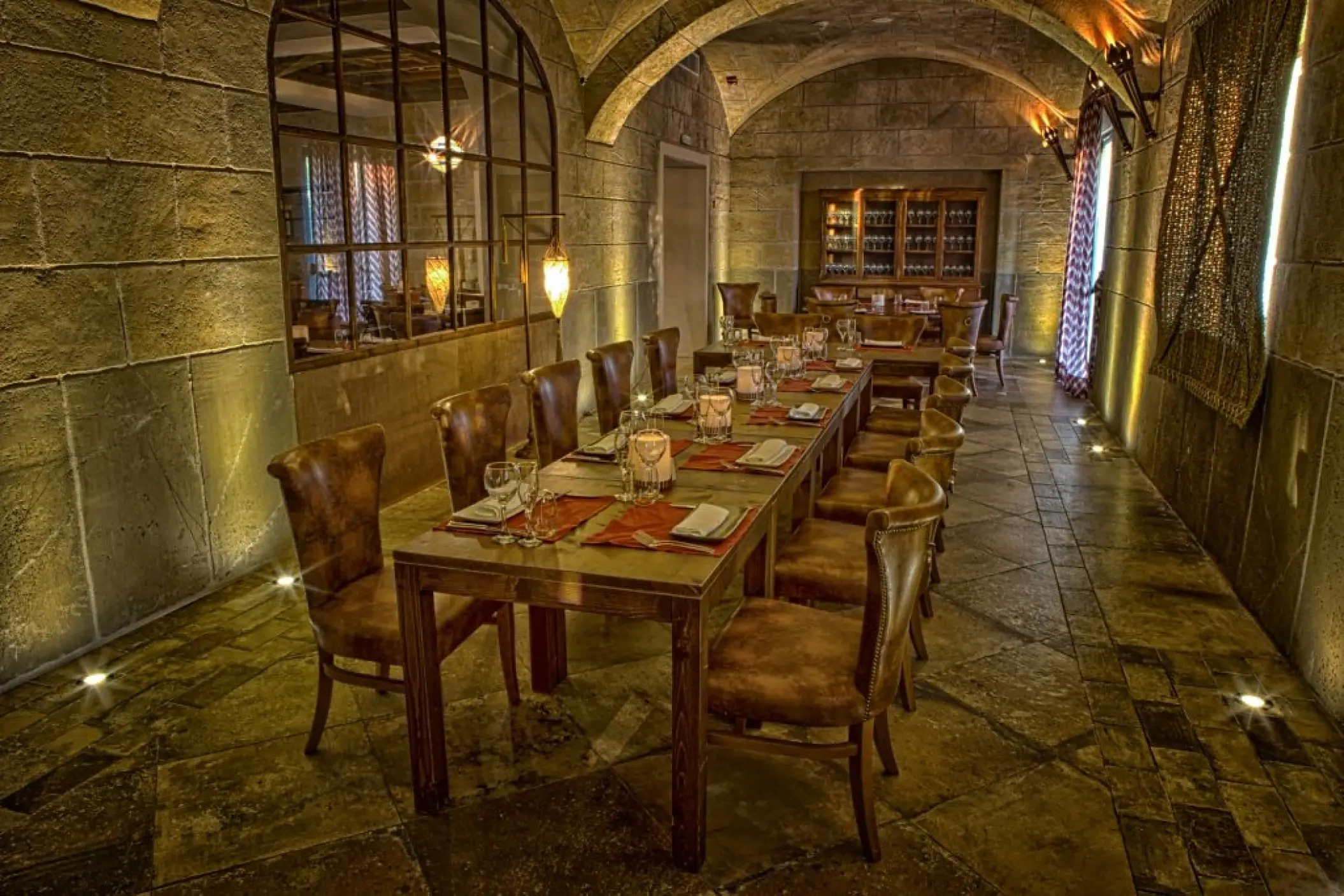 Don Jaume steakhouse dining area with stone walls at Majestic Mirage, Punta Cana
