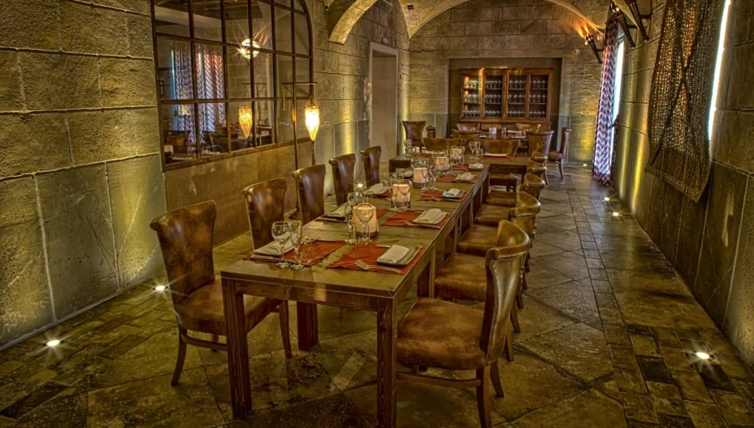 Don Jaume steakhouse dining area with stone walls at Majestic Mirage, Punta Cana