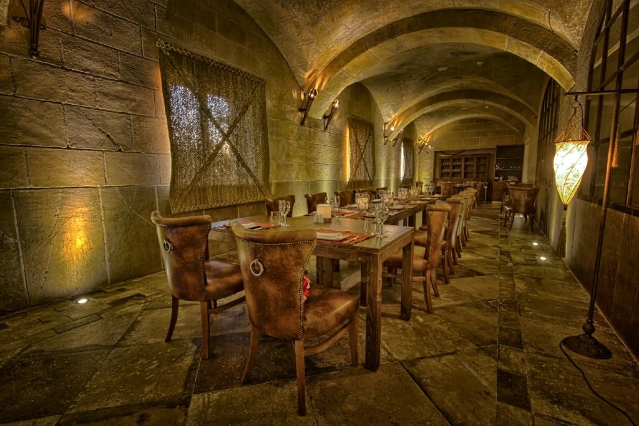 Stone-walled dining room setup for a wedding reception at Majestic Mirage, Punta Cana