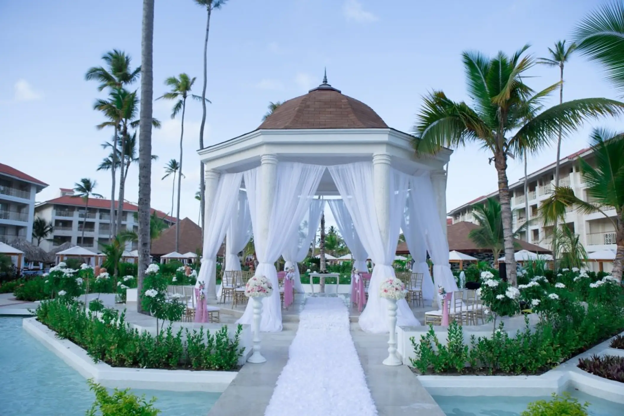 Garden gazebo wedding ceremony setup with white drapes at Majestic Mirage, Punta Cana