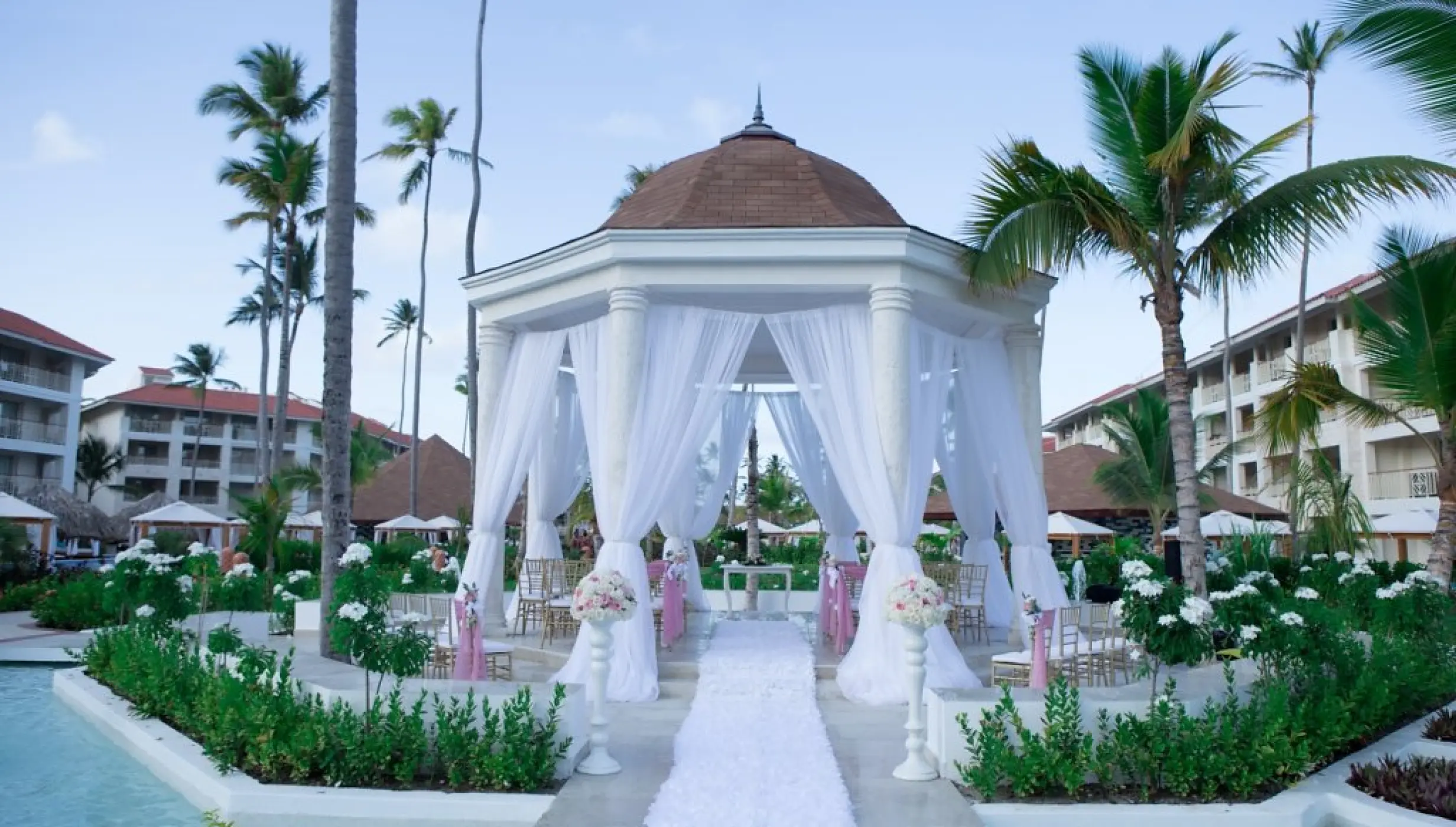 Garden gazebo wedding ceremony setup with white drapes at Majestic Mirage, Punta Cana