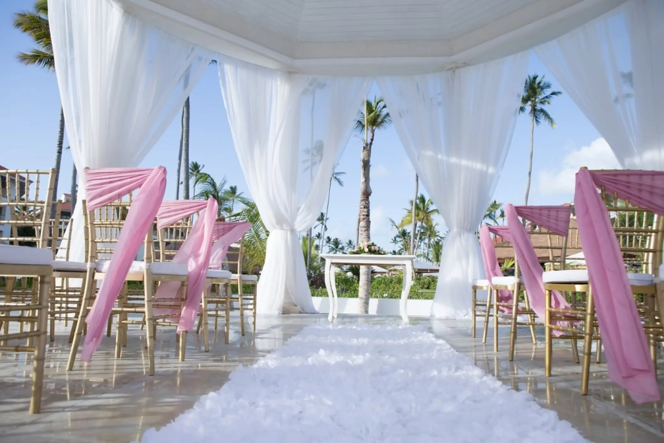 Garden gazebo wedding ceremony with pink sashes at Majestic Mirage, Punta Cana