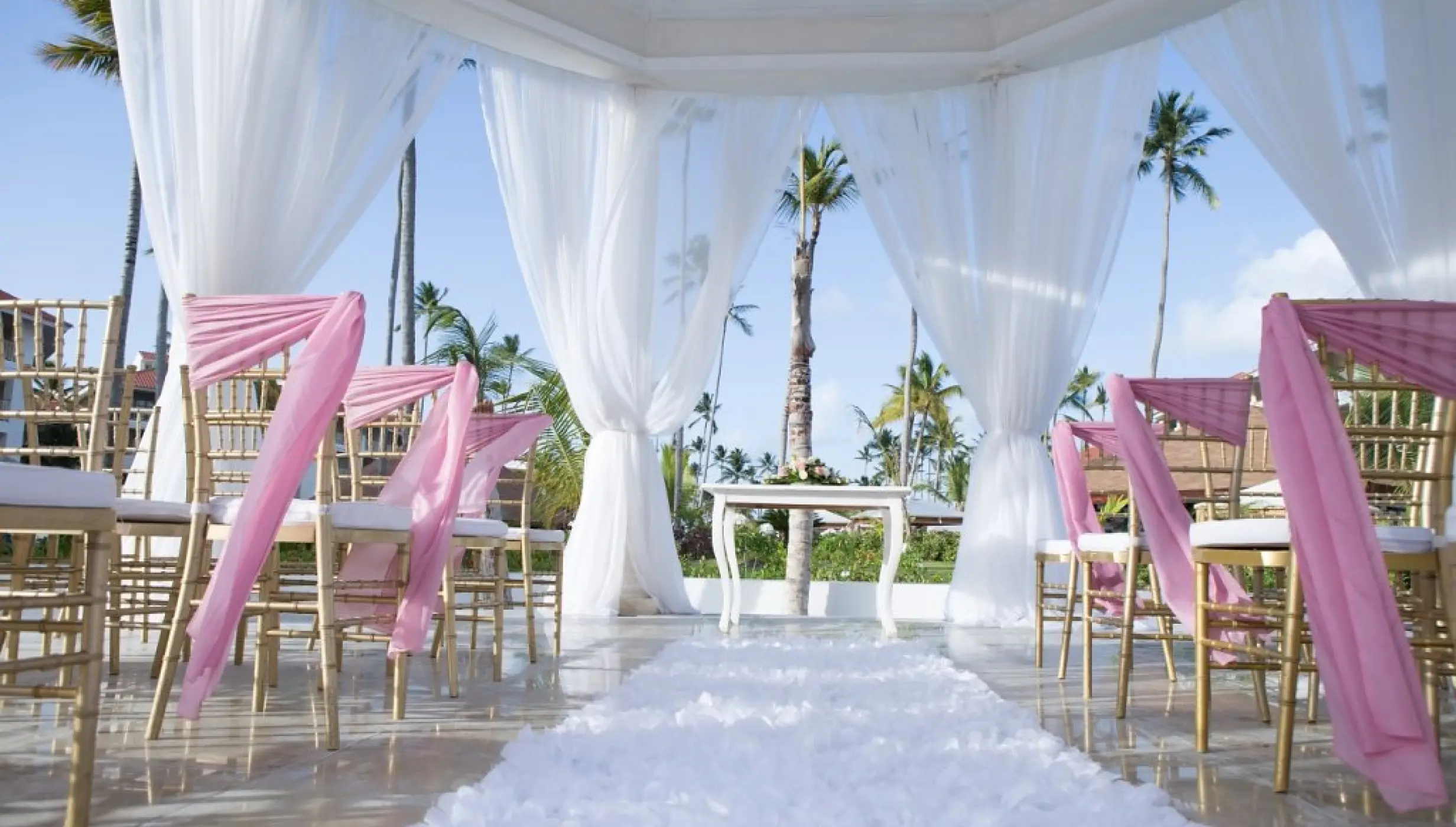 Garden gazebo wedding ceremony with pink sashes at Majestic Mirage, Punta Cana