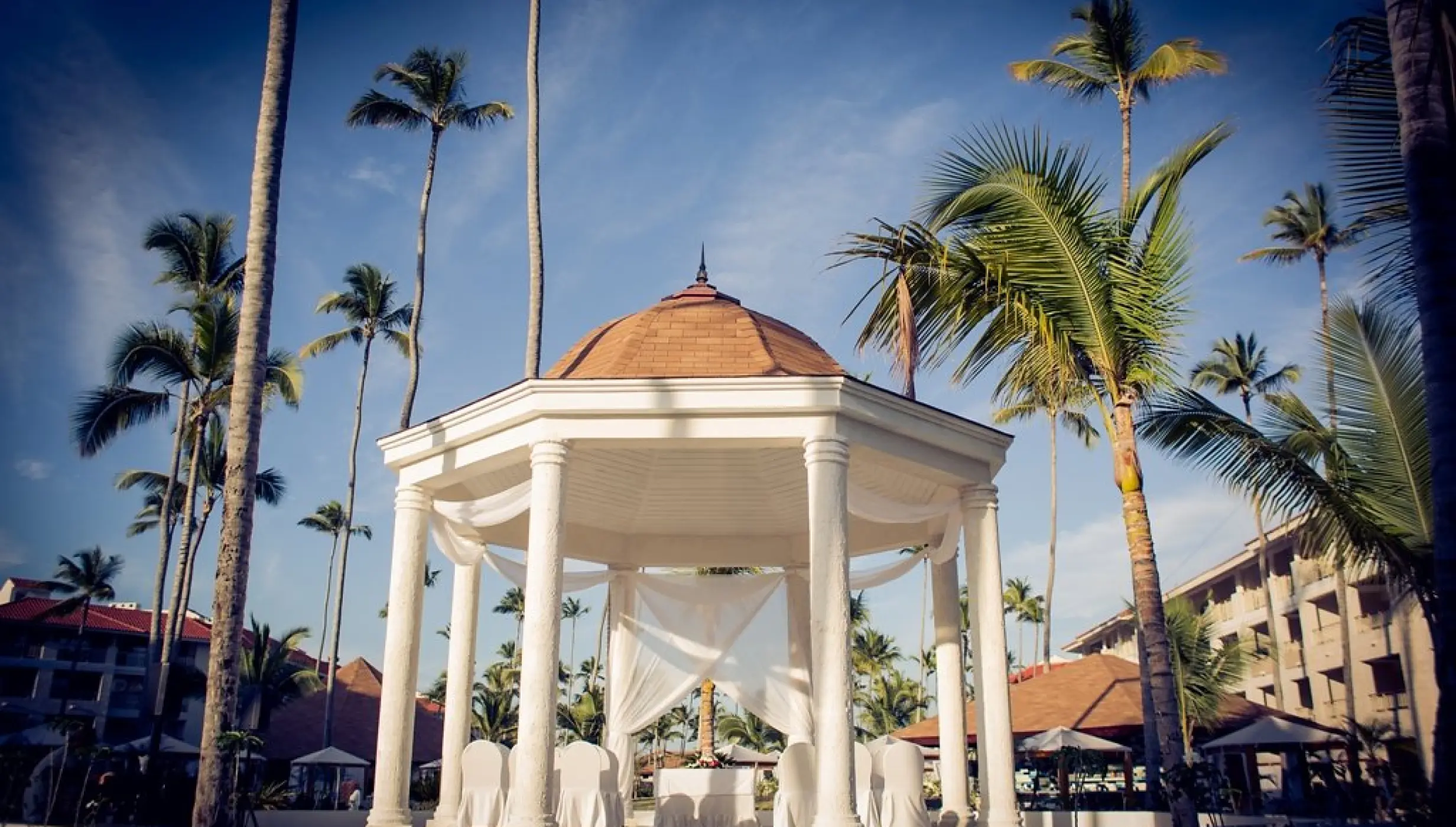 Garden gazebo wedding ceremony setup with white draping at Majestic Mirage, Punta Cana