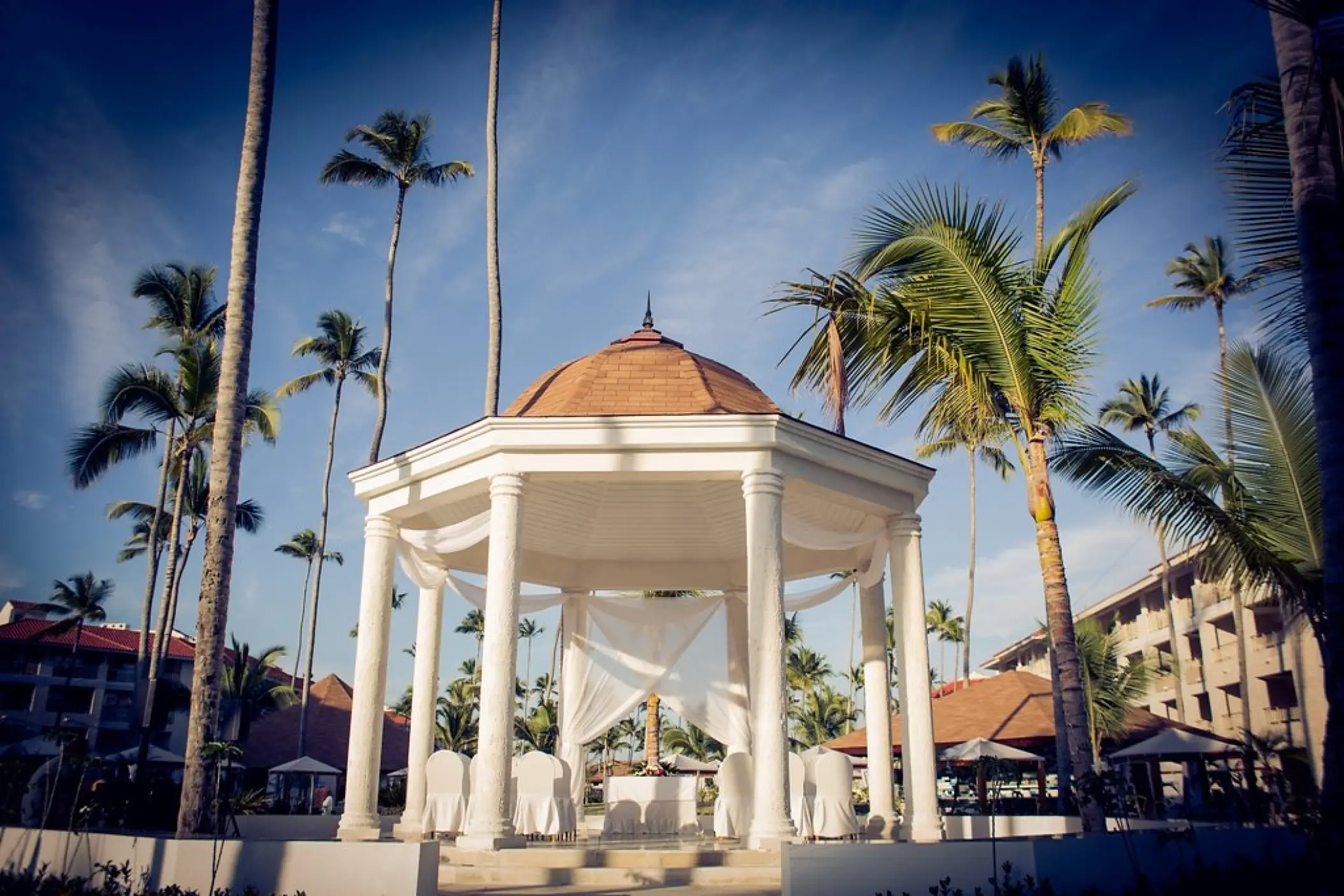 Garden gazebo wedding ceremony setup with white draping at Majestic Mirage, Punta Cana