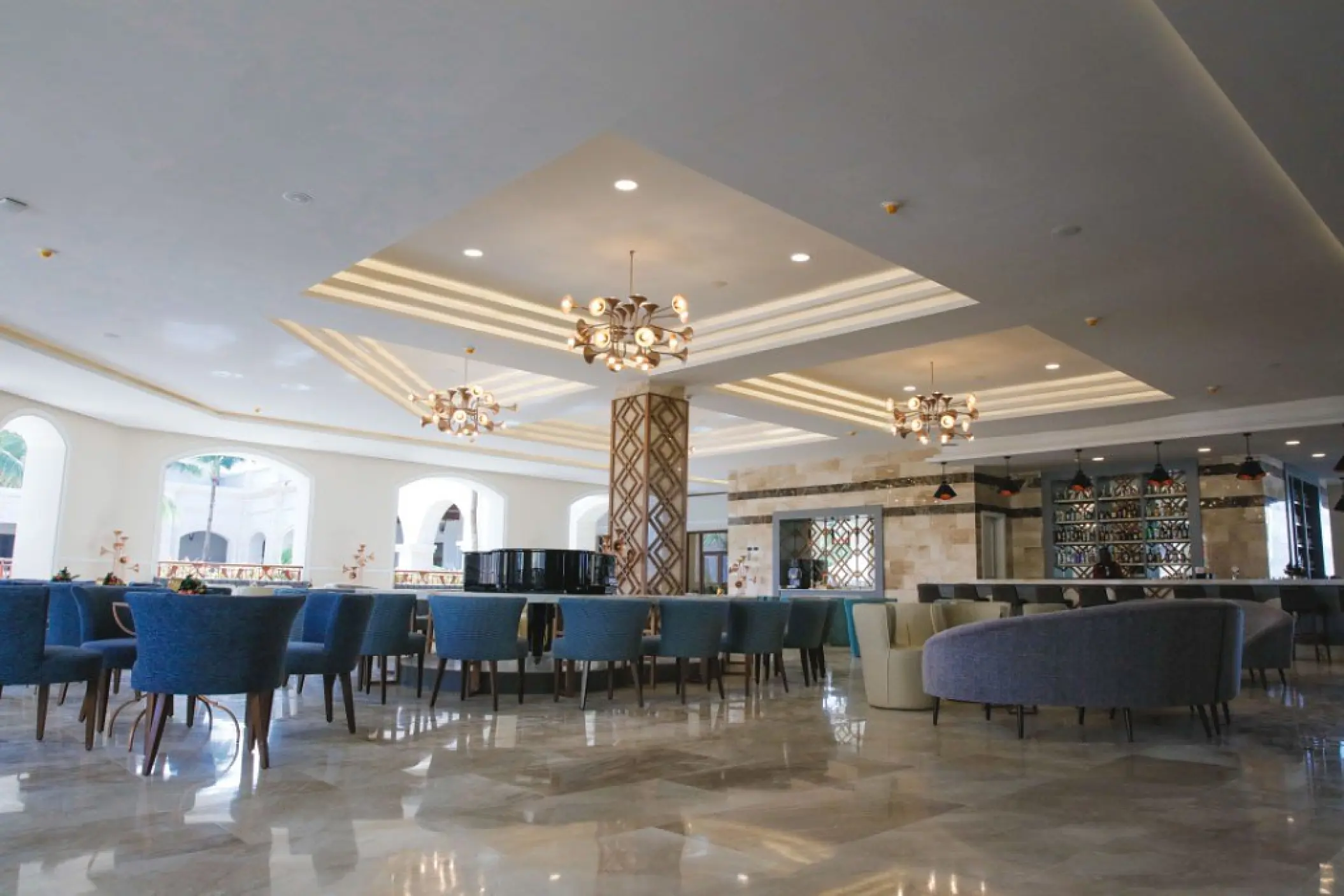 Piano bar lounge with blue armchairs at Majestic Mirage Punta Cana, Punta Cana