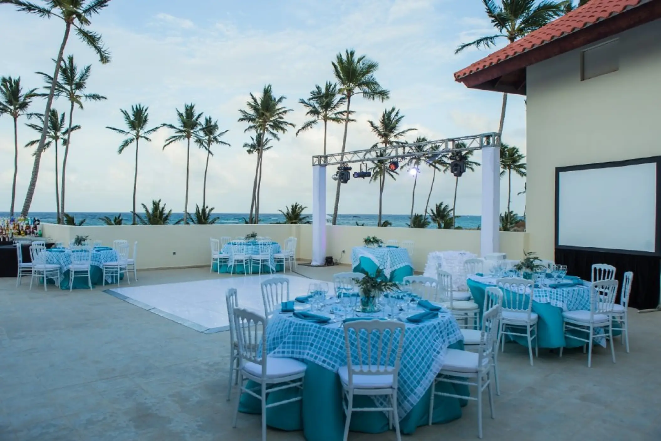 Terrace wedding reception with blue and white decor at Majestic Mirage, Punta Cana