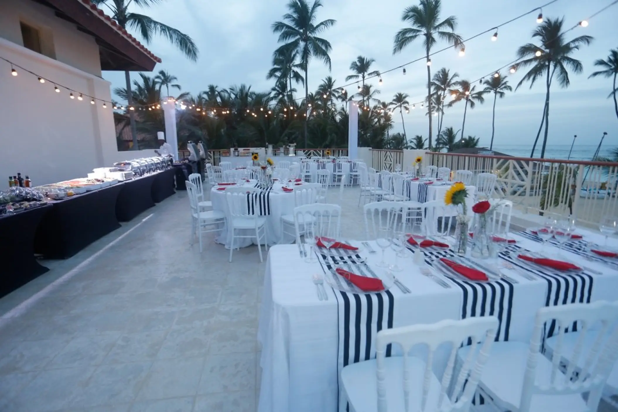 Private terrace wedding reception with string lights at Majestic Mirage, Punta Cana