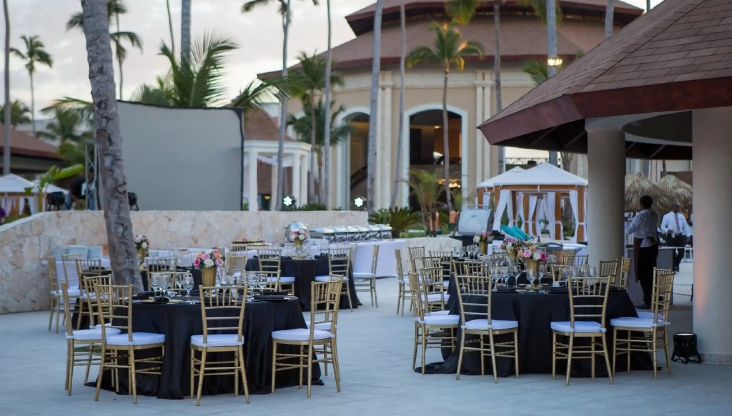 Outdoor wedding reception with black linens and gold chairs at Majestic Mirage, Punta Cana