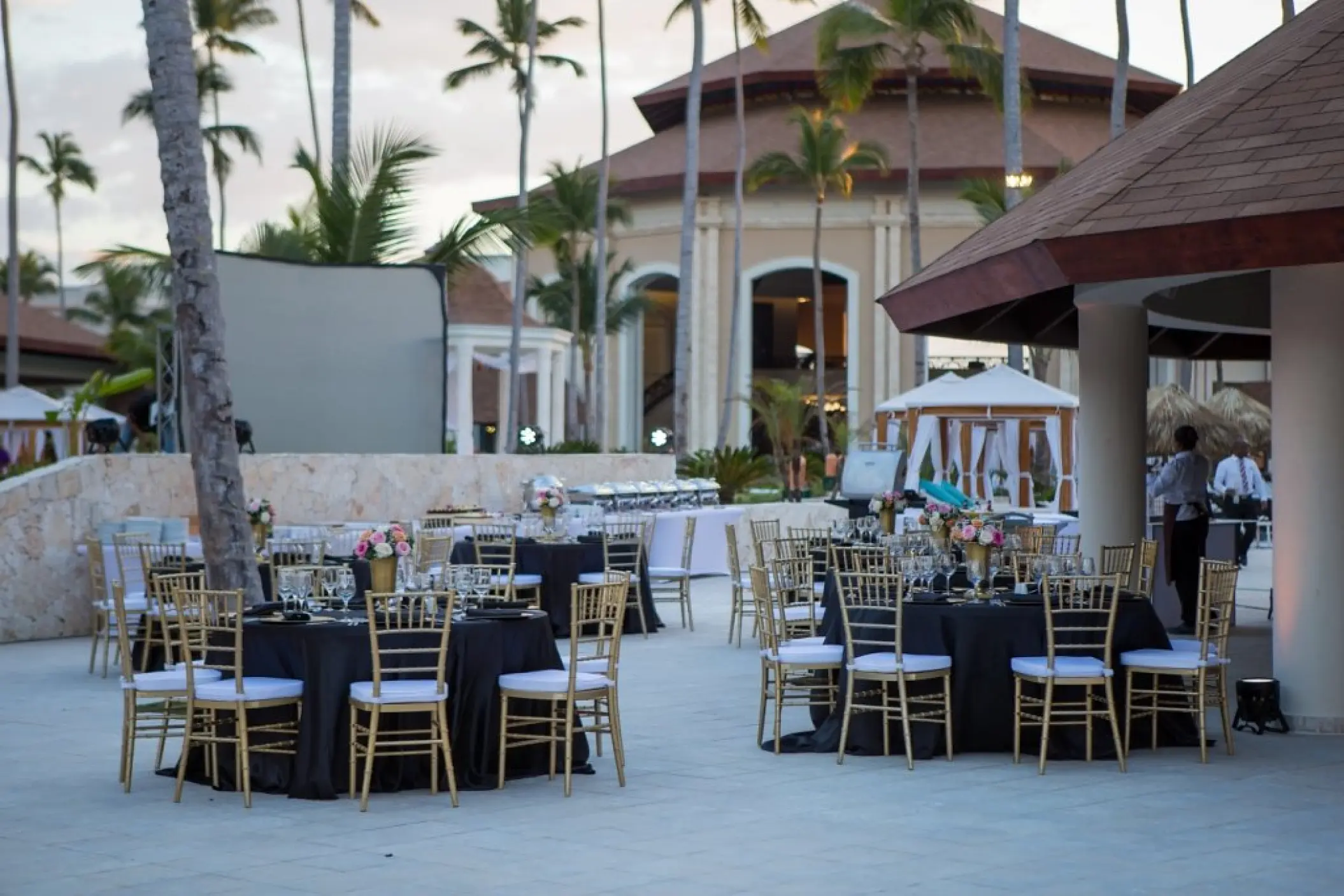 Outdoor wedding reception with black linens and gold chairs at Majestic Mirage, Punta Cana