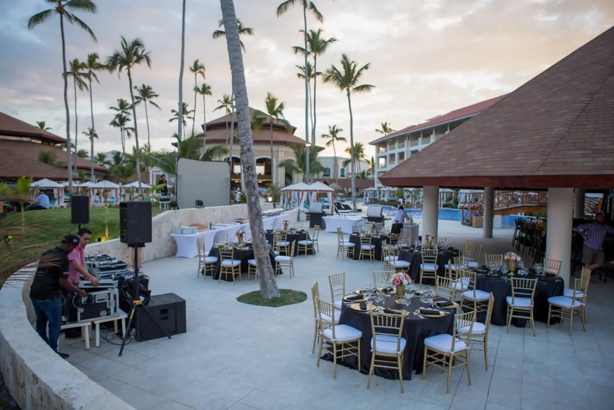 Outdoor wedding reception setup with gold chairs and black linens at Majestic Mirage, Punta Cana