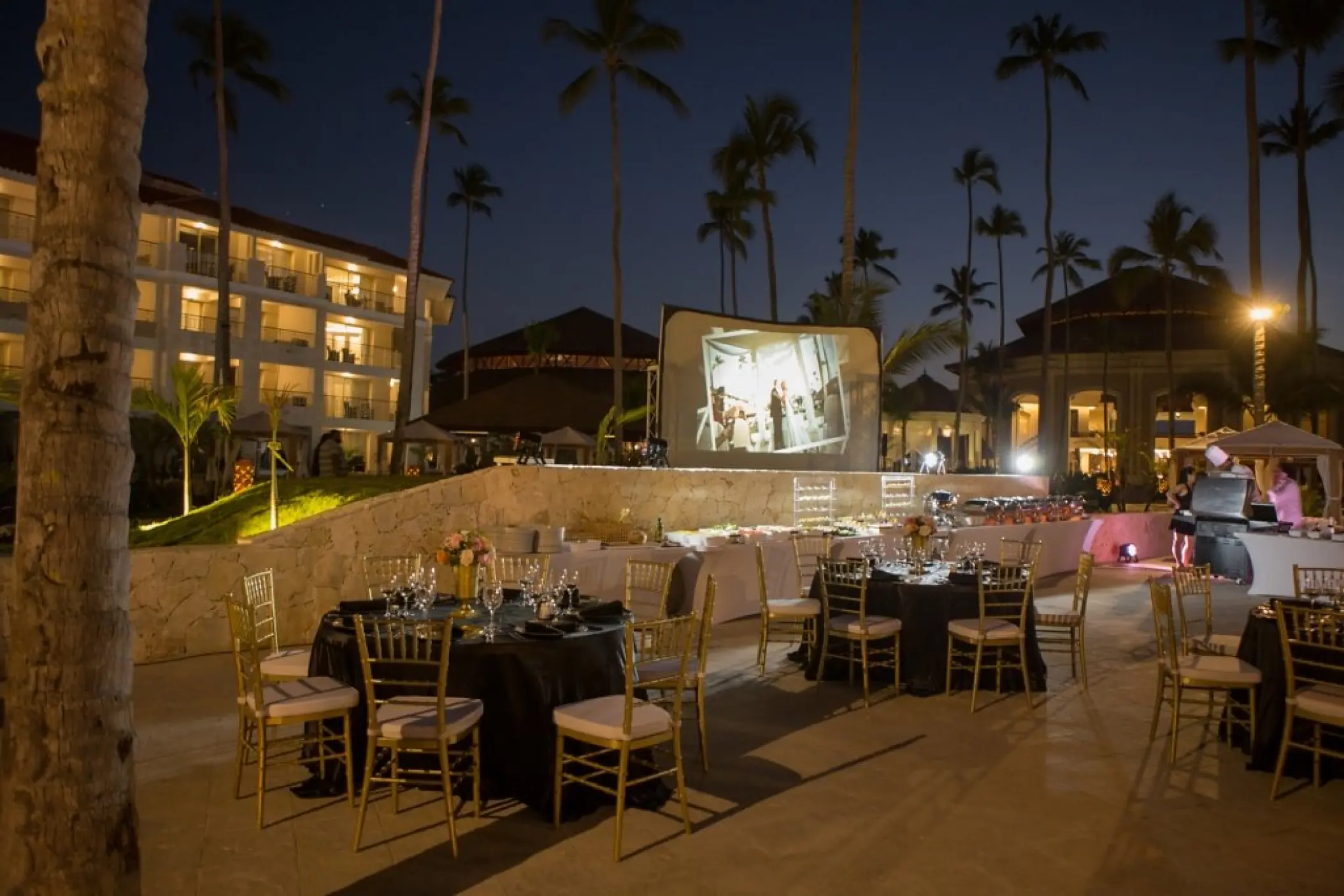 Evening wedding reception with a projector screen at Majestic Mirage Punta Cana