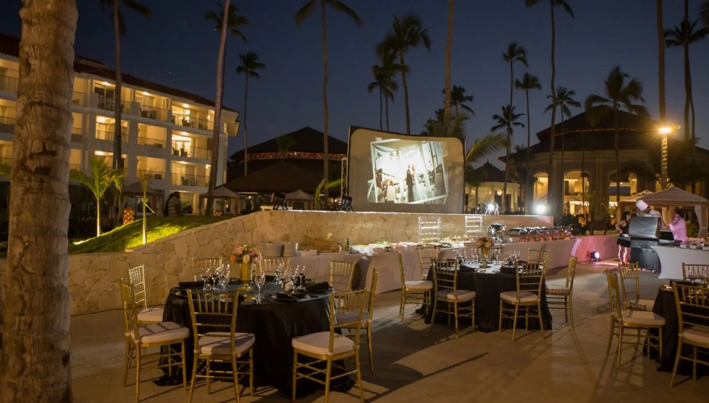 Evening wedding reception with a projector screen at Majestic Mirage Punta Cana