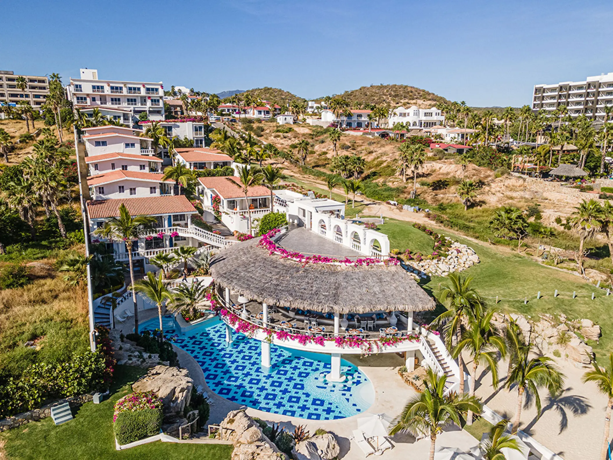 Aerial view of the tiled swimming pool and thatched roof terrace at Mar Del Cabo, Cabo San Lucas