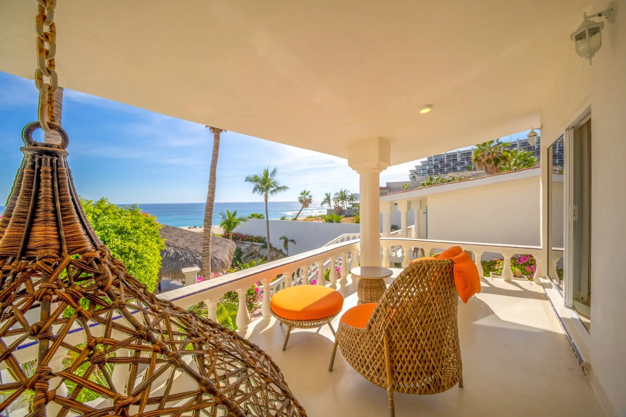 Private balcony with wicker furniture and ocean views at Mar Del Cabo, Cabo San Lucas