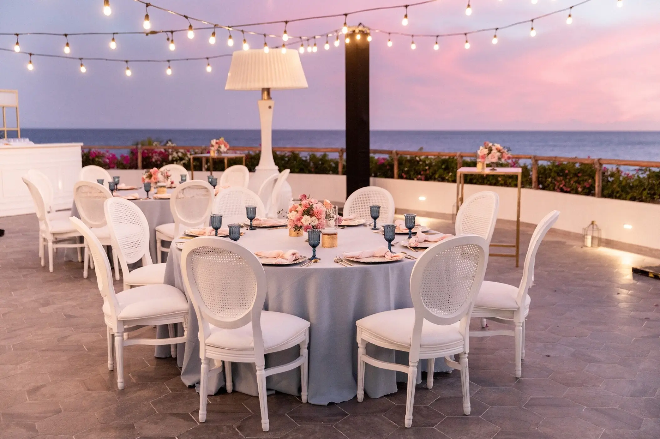 Outdoor wedding reception at Mar Del Cabo, Cabo San Lucas under string lights at sunset