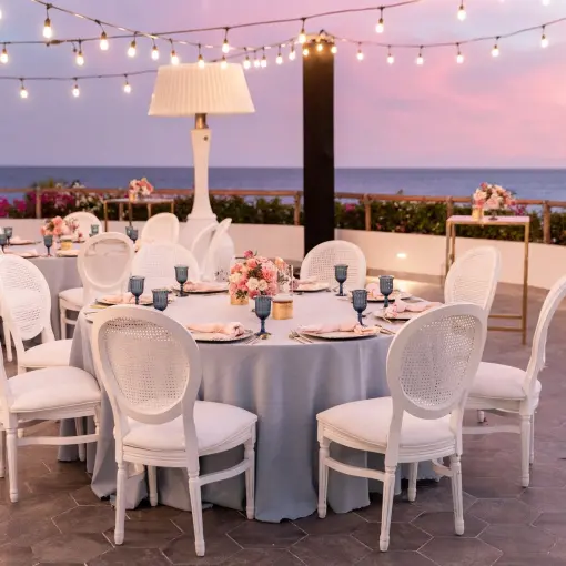 Outdoor wedding reception at Mar Del Cabo, Cabo San Lucas under string lights at sunset
