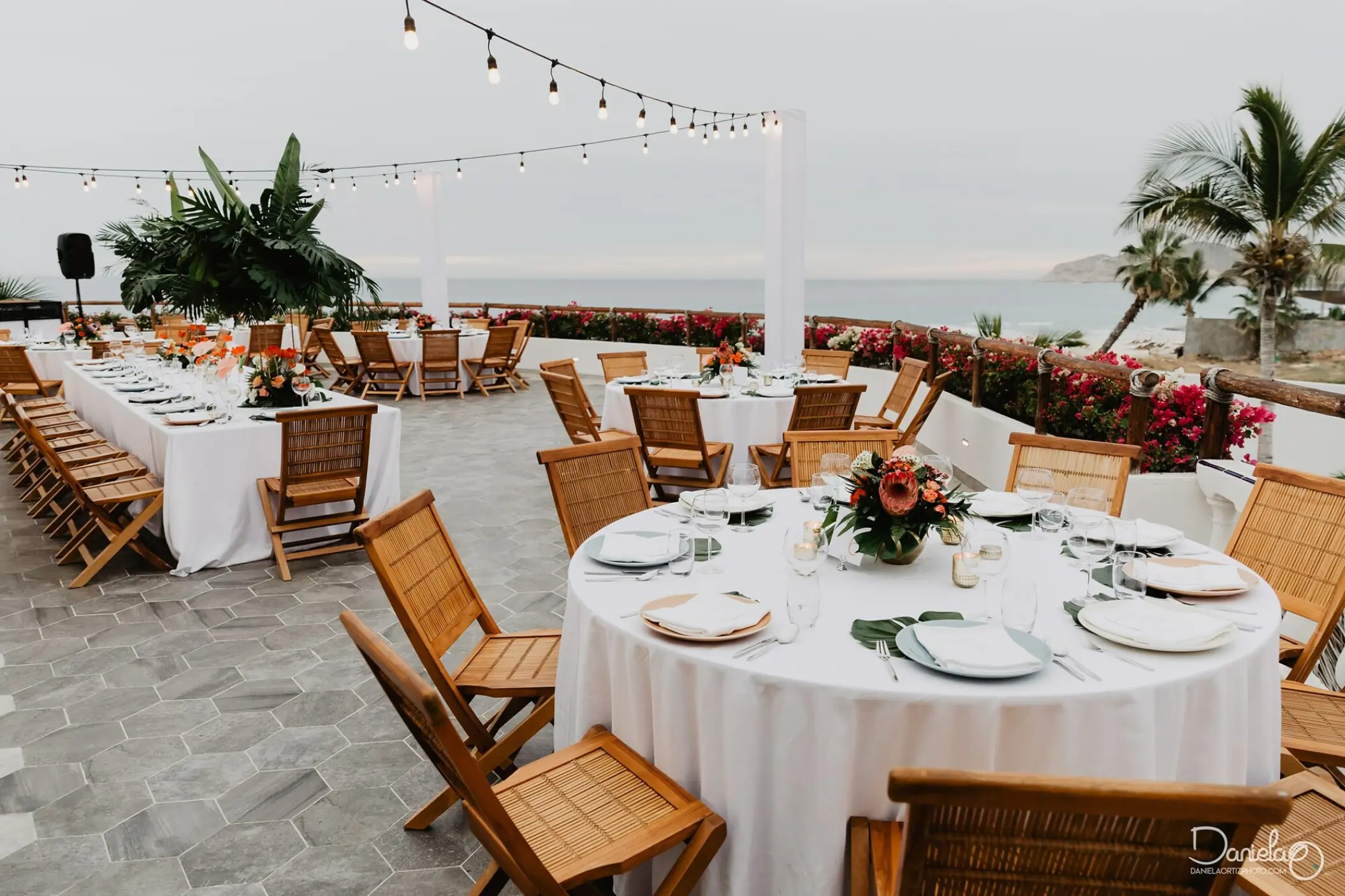 Outdoor wedding reception with string lights on the terrace at Mar Del Cabo, Cabo San Lucas