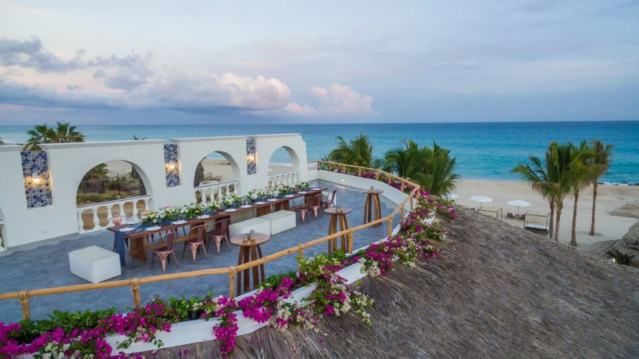 Terrace wedding reception with floral decor overlooking the ocean at Mar Del Cabo, Cabo San Lucas