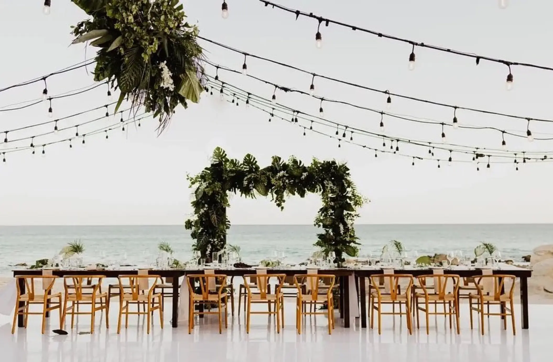Patio wedding reception setup with ocean views and string lights at Mar Del Cabo, Cabo San Lucas