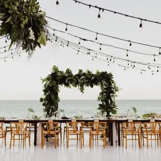 Patio wedding reception setup with ocean views and string lights at Mar Del Cabo, Cabo San Lucas