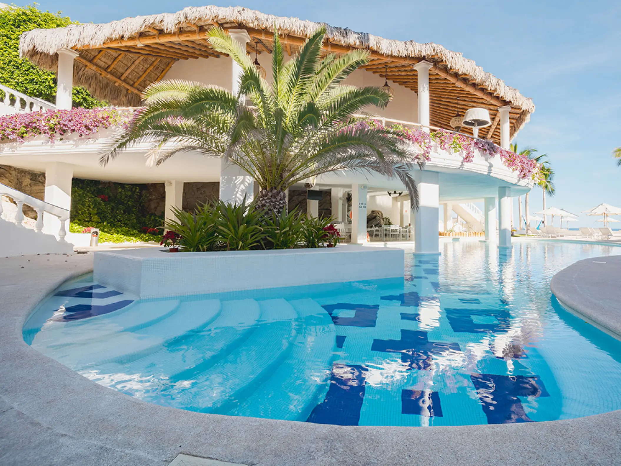 Mar Del Cabo outdoor swimming pool and thatched-roof pavilion, Cabo San Lucas
