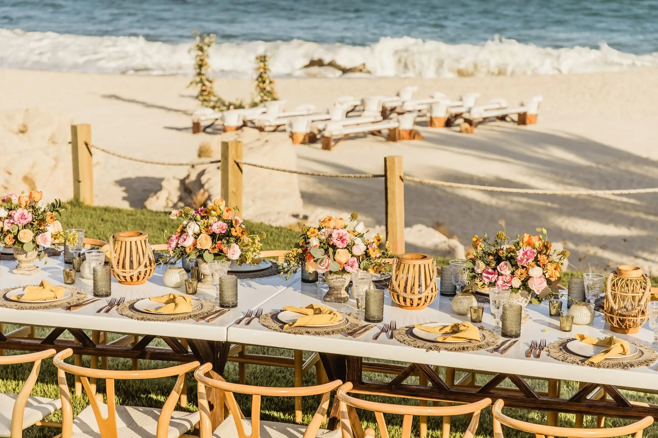 Terrace wedding reception overlooking a beach ceremony setup at Mar Del Cabo, Cabo San Lucas