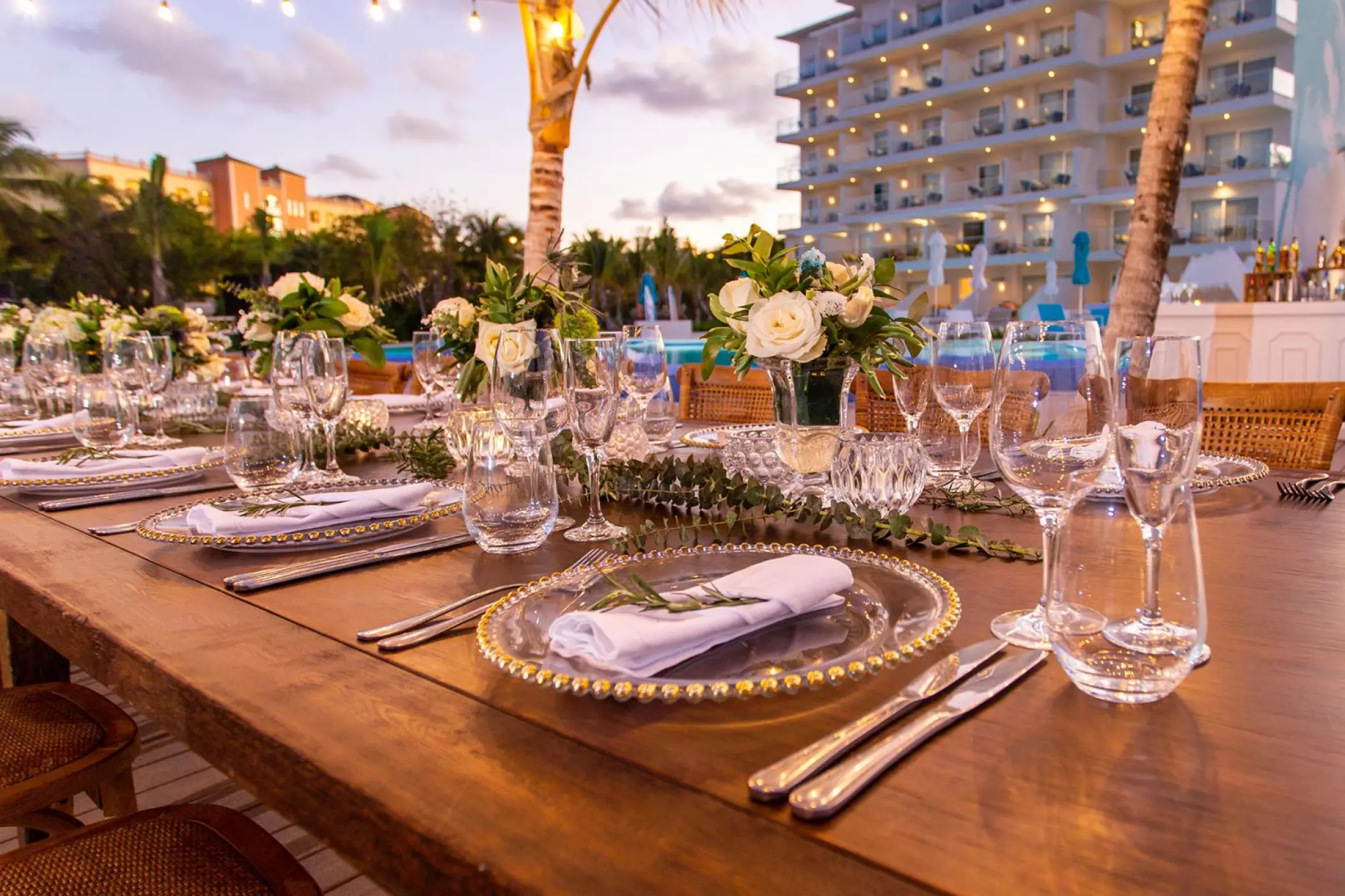 Outdoor wedding reception table with white floral centerpieces at Margaritaville Cap Cana, Punta Cana