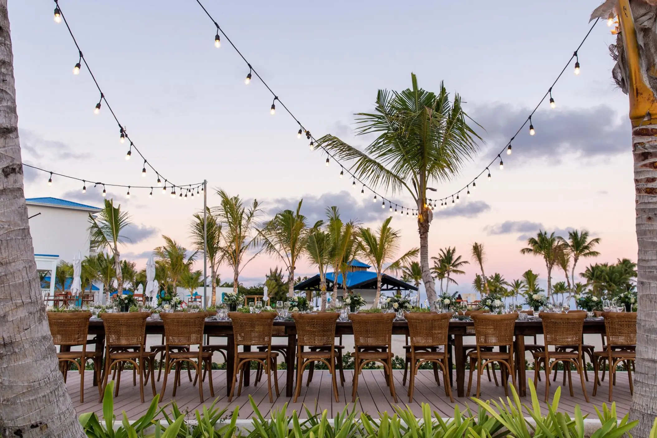 Outdoor wedding reception with long tables and string lights at Margaritaville Cap Cana, Punta Cana