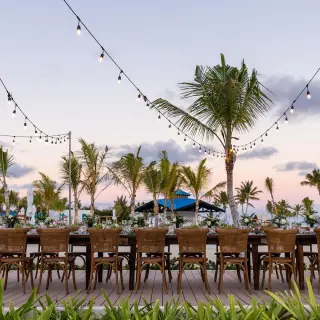 Outdoor wedding reception with long tables and string lights at Margaritaville Cap Cana, Punta Cana