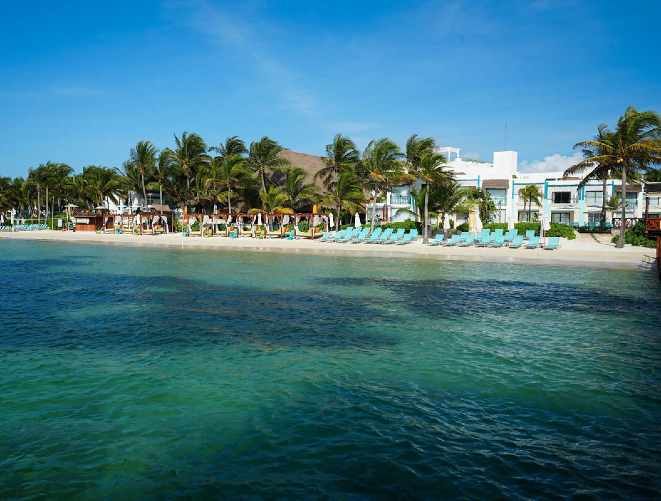 White sand beach and palm trees at Margaritaville Island Reserve Riviera Cancun, Cancun