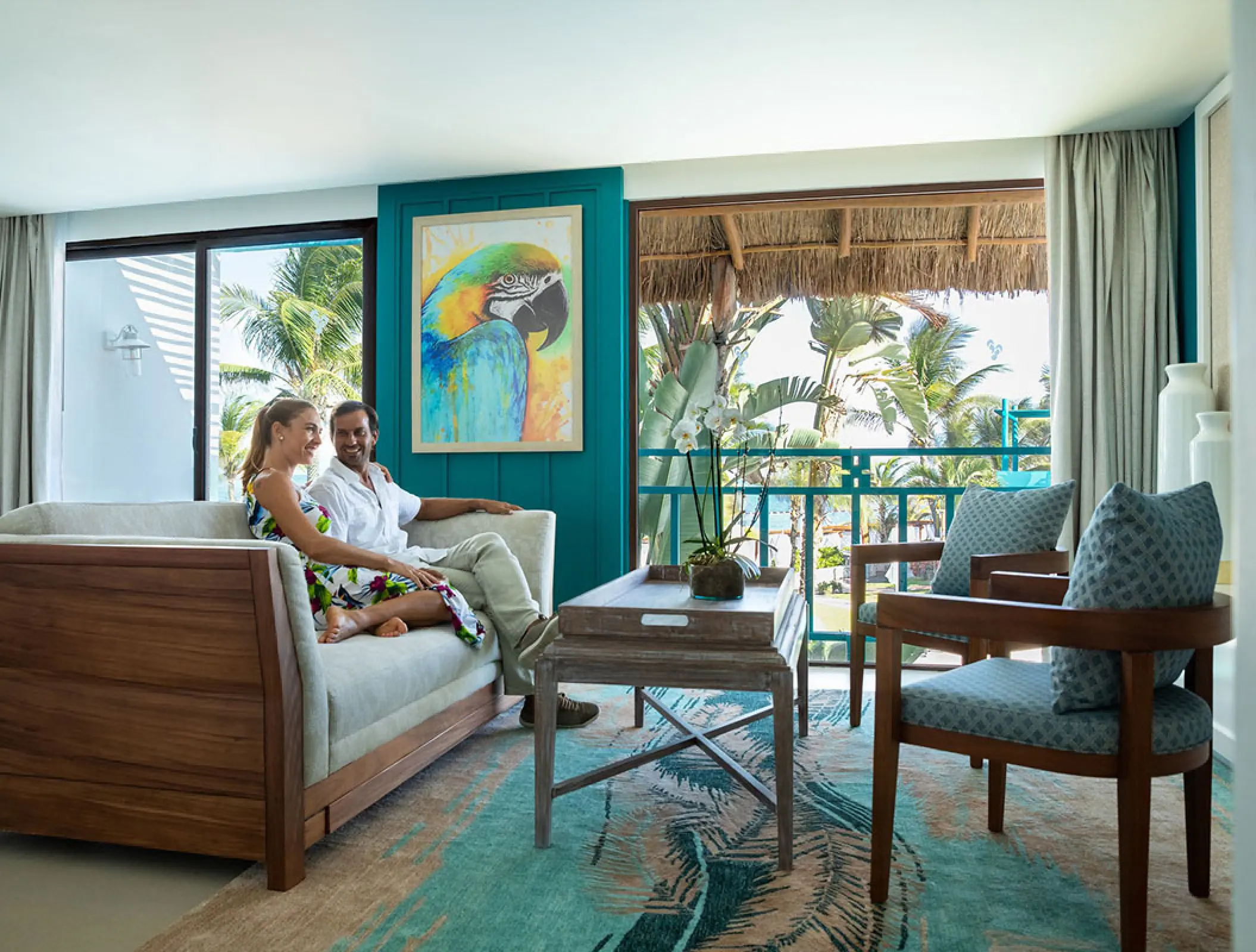 Couple relaxing in a suite living area at Margaritaville Island Reserve Riviera Cancun, Cancun
