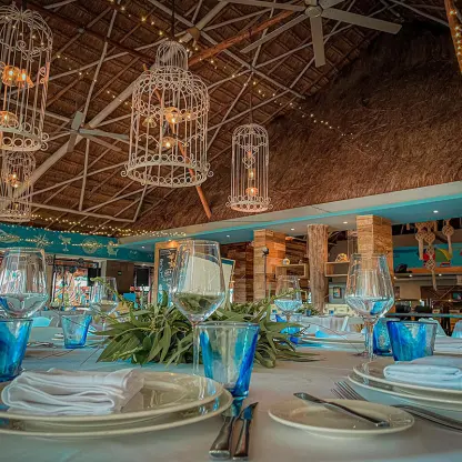 Table setting for a wedding reception under a palapa at Margaritaville Island Reserve Riviera Cancun, Cancun