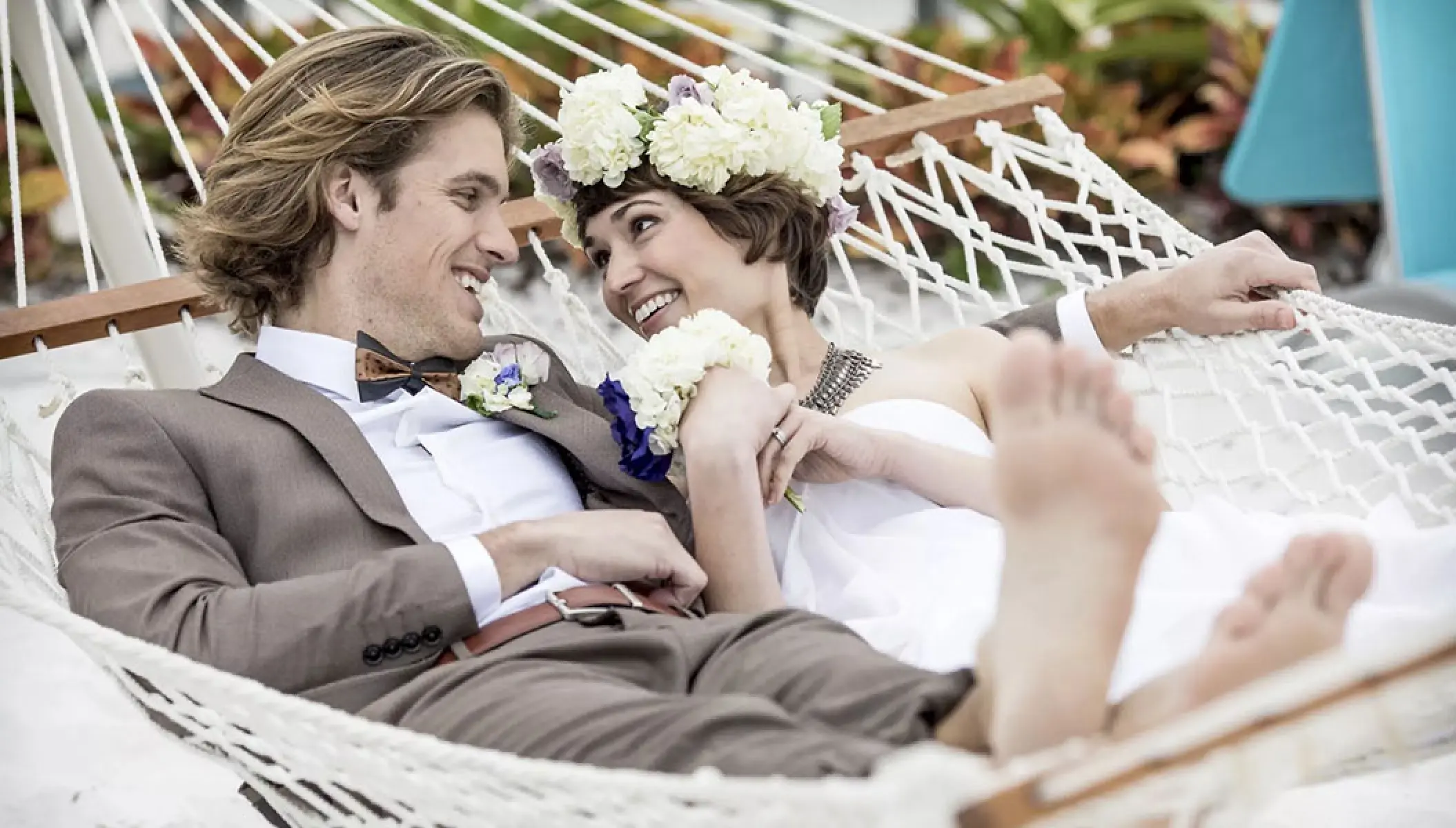 The bride and groom relaxing in a white hammock at Margaritaville Island Reserve Riviera Maya