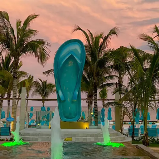 Giant turquoise flip-flop statue and fountains at Margaritaville Island Reserve, Riviera Maya