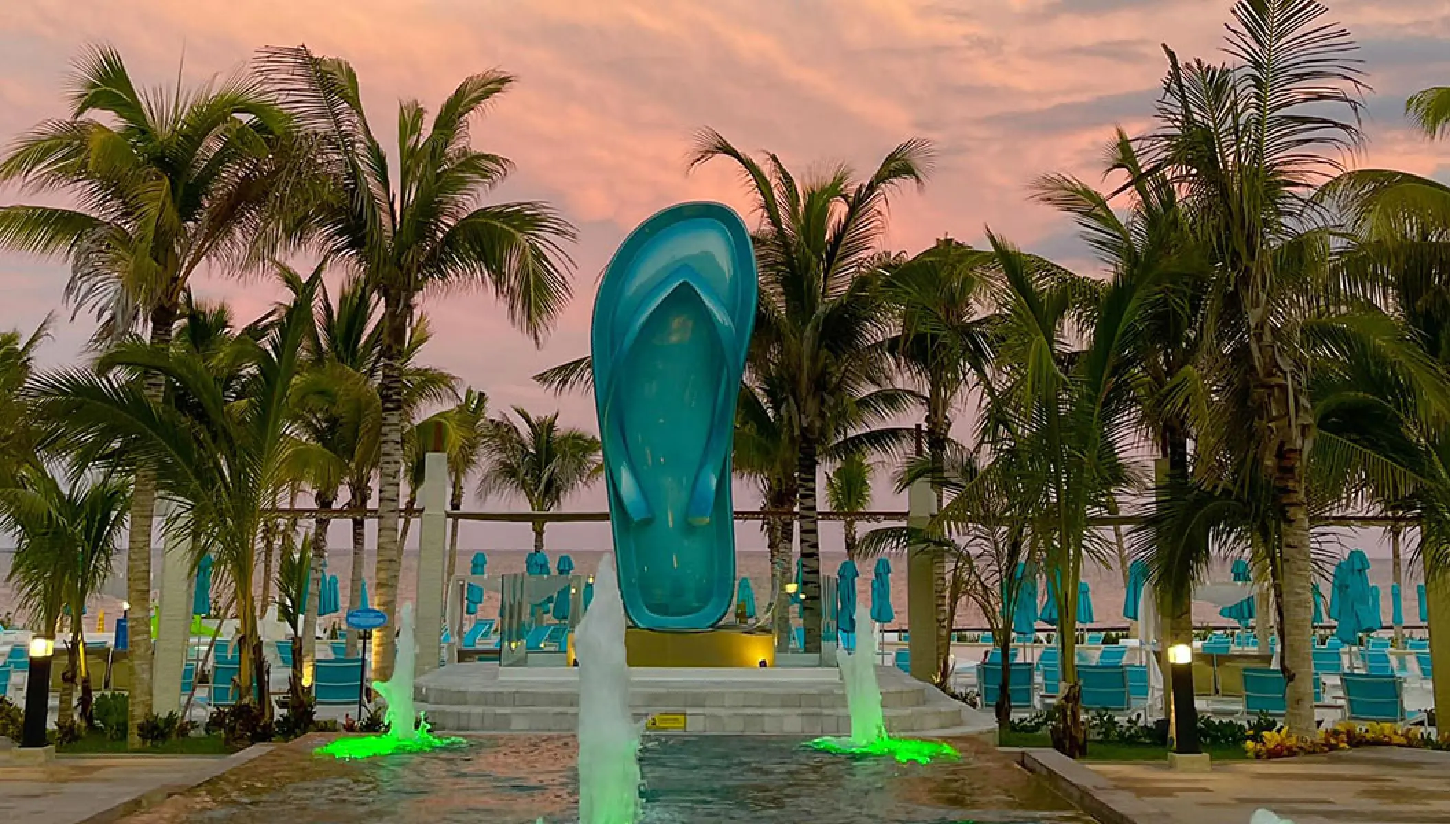 Giant turquoise flip-flop statue and fountains at Margaritaville Island Reserve, Riviera Maya
