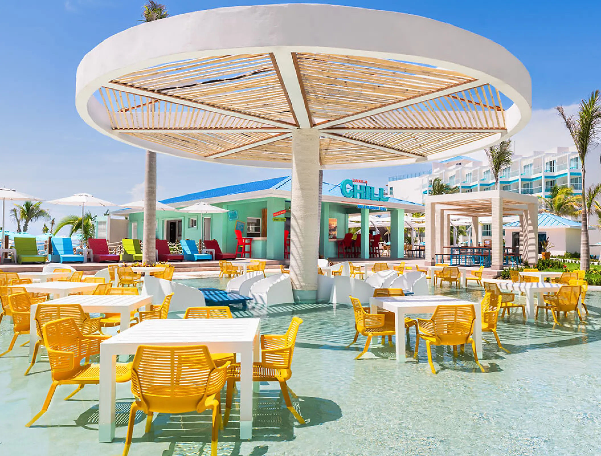 Margaritaville Riviera Maya License to Chill wet feet bar with yellow chairs in shallow pool water