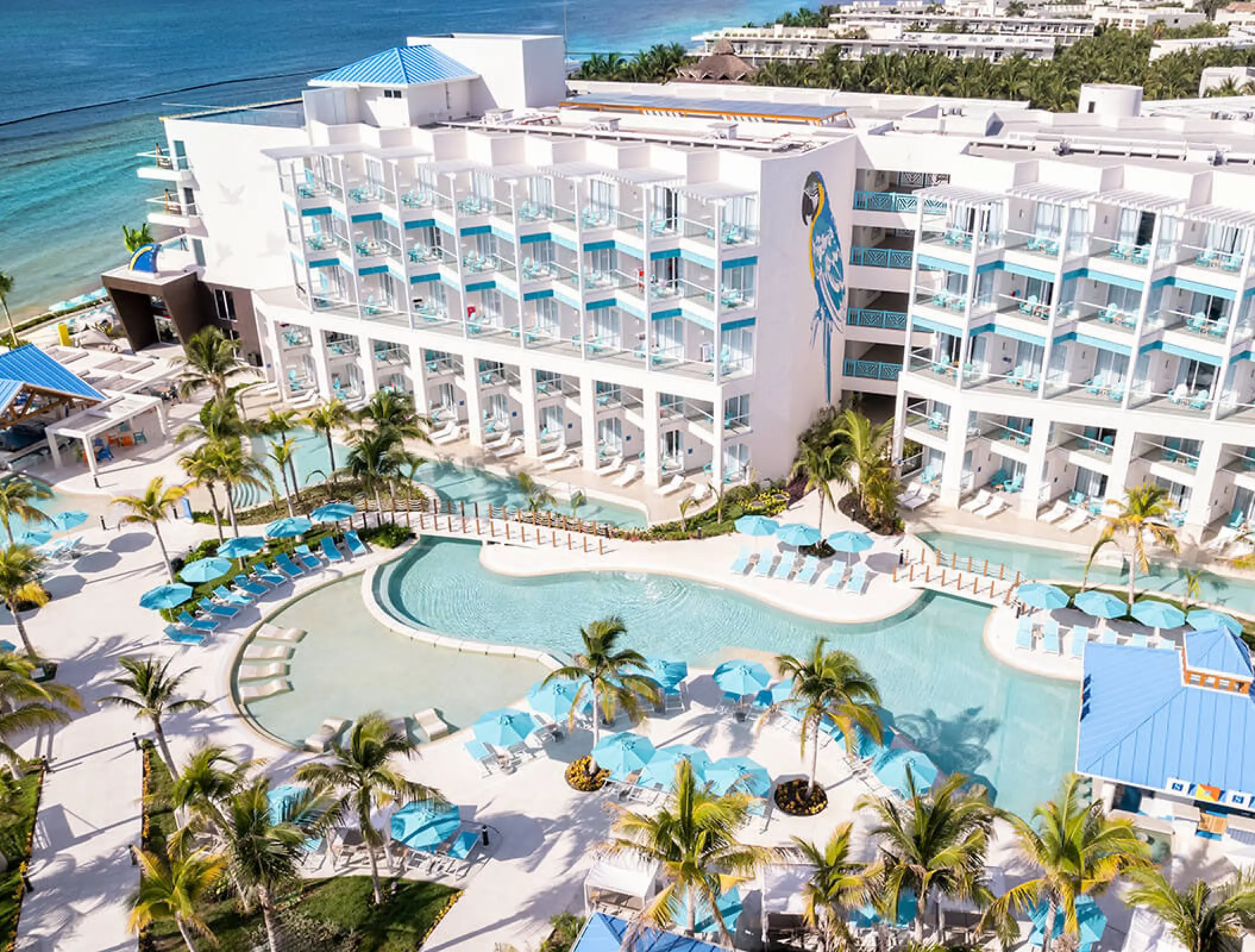 Aerial view of swimming pools and guest room balconies at Margaritaville Island Reserve Riviera Maya