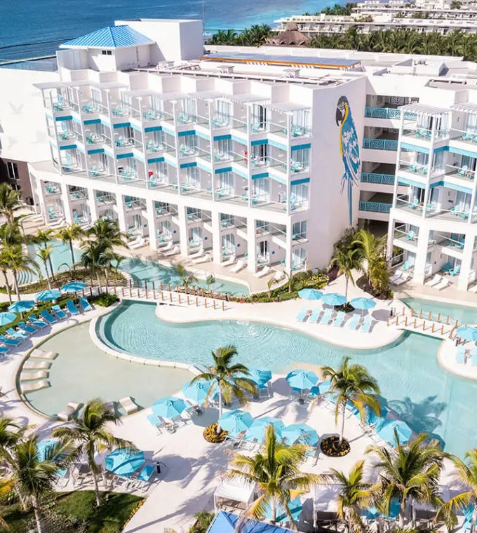 Aerial view of swimming pools and guest room balconies at Margaritaville Island Reserve Riviera Maya