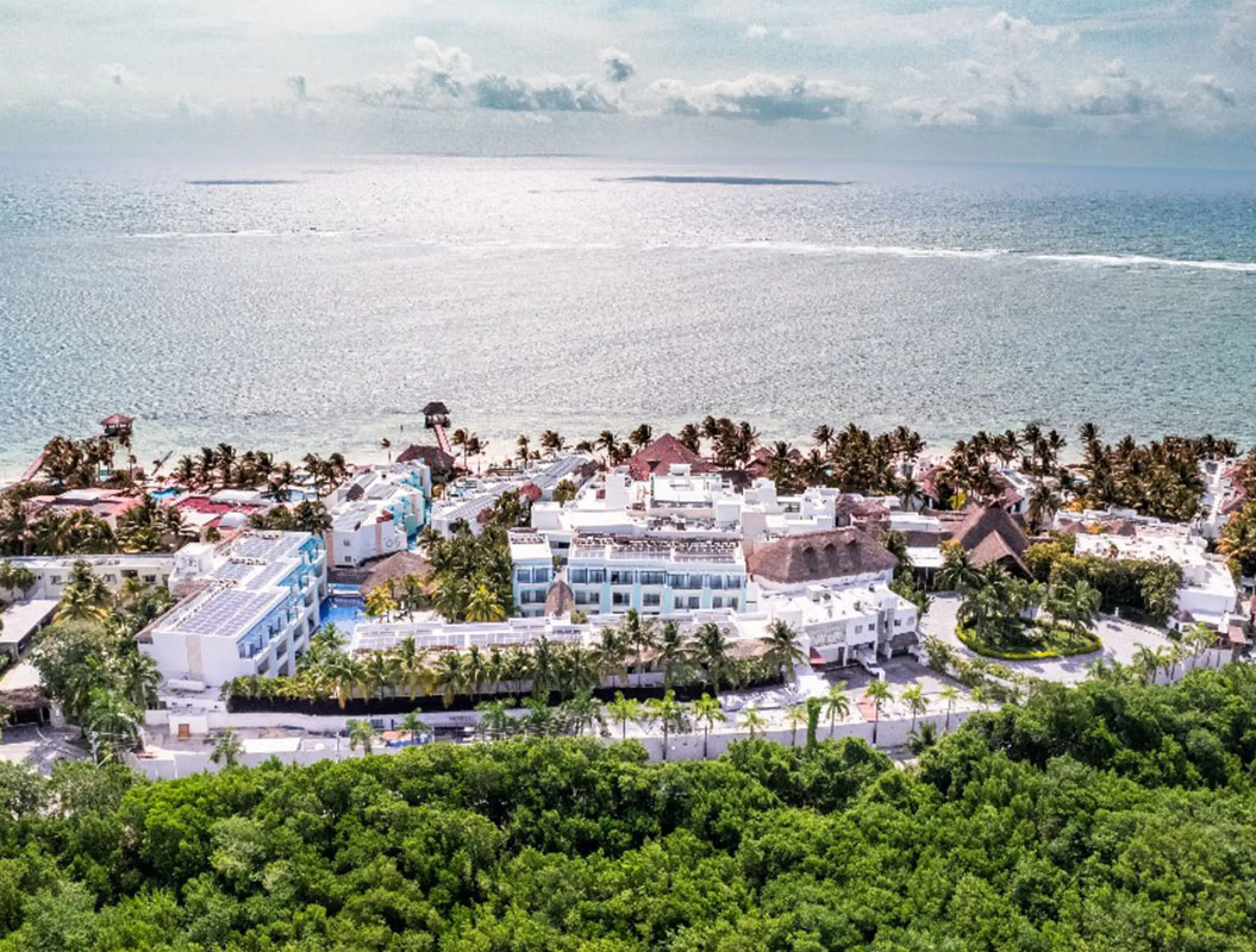 Aerial view of Margaritaville Island Reserve Riviera Cancun buildings and beachfront, Cancun