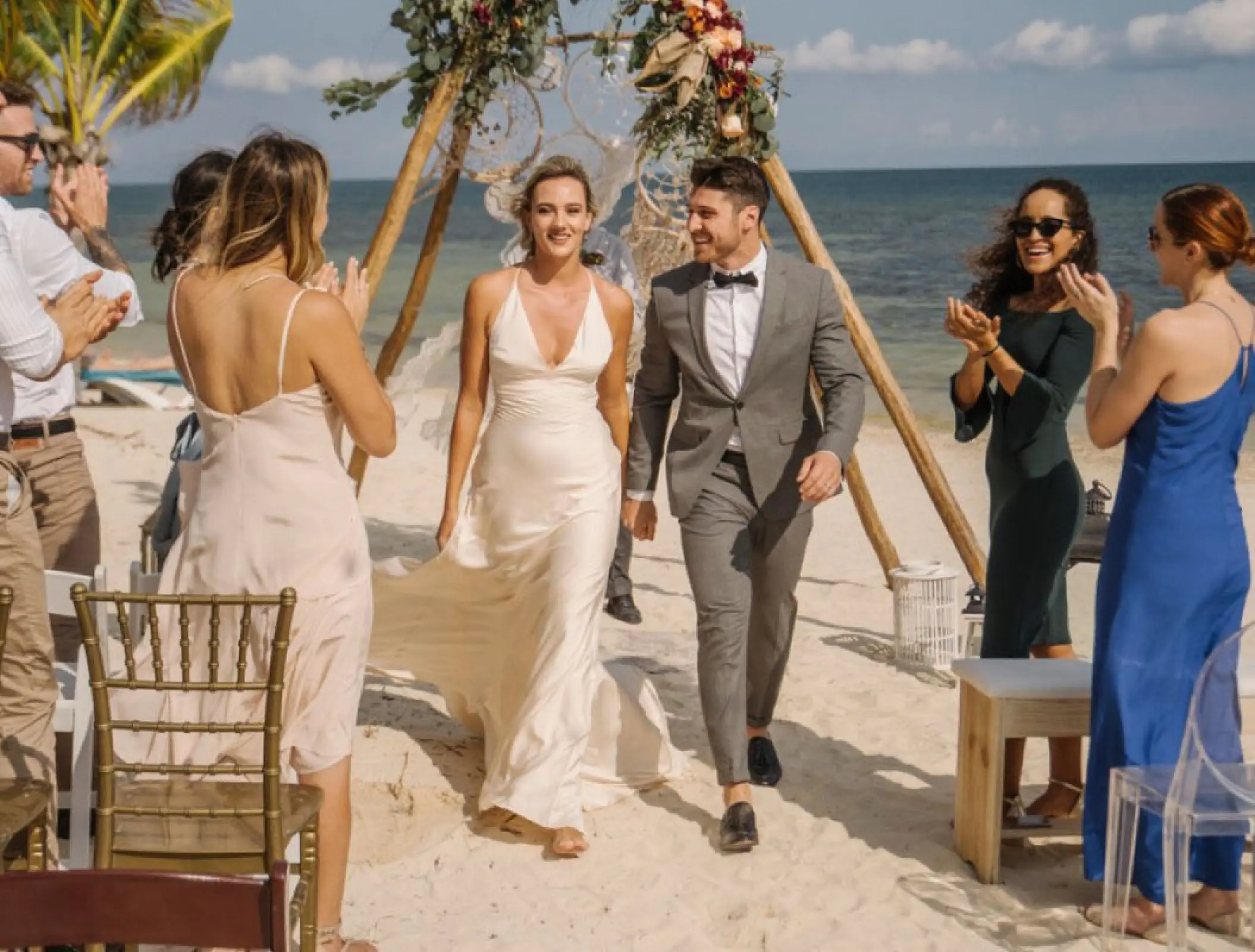 Bride and groom walking down the aisle at Margaritaville Island Reserve Riviera Cancun