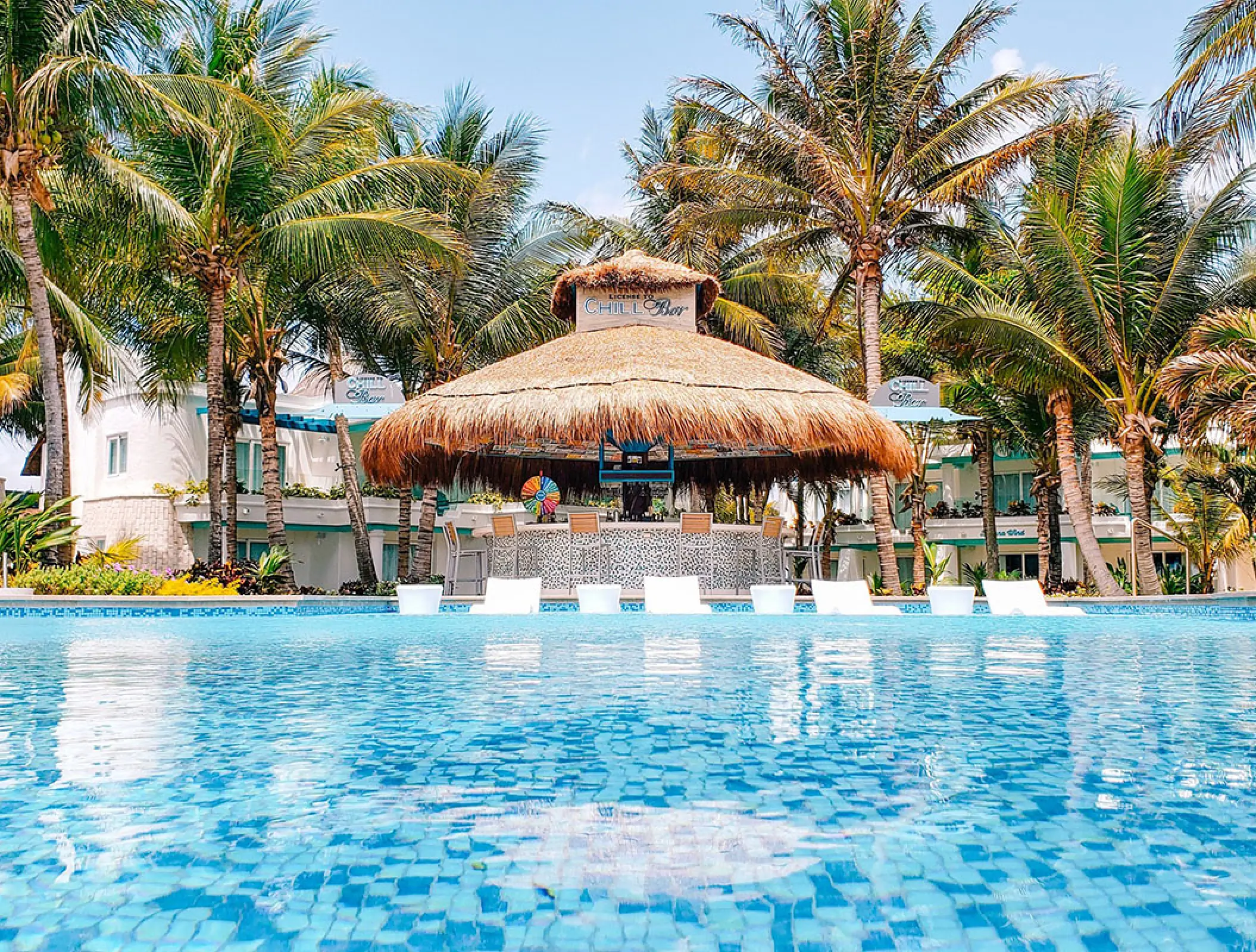 Swim-up bar with a thatched roof at Margaritaville Island Reserve Riviera Cancun, Cancun