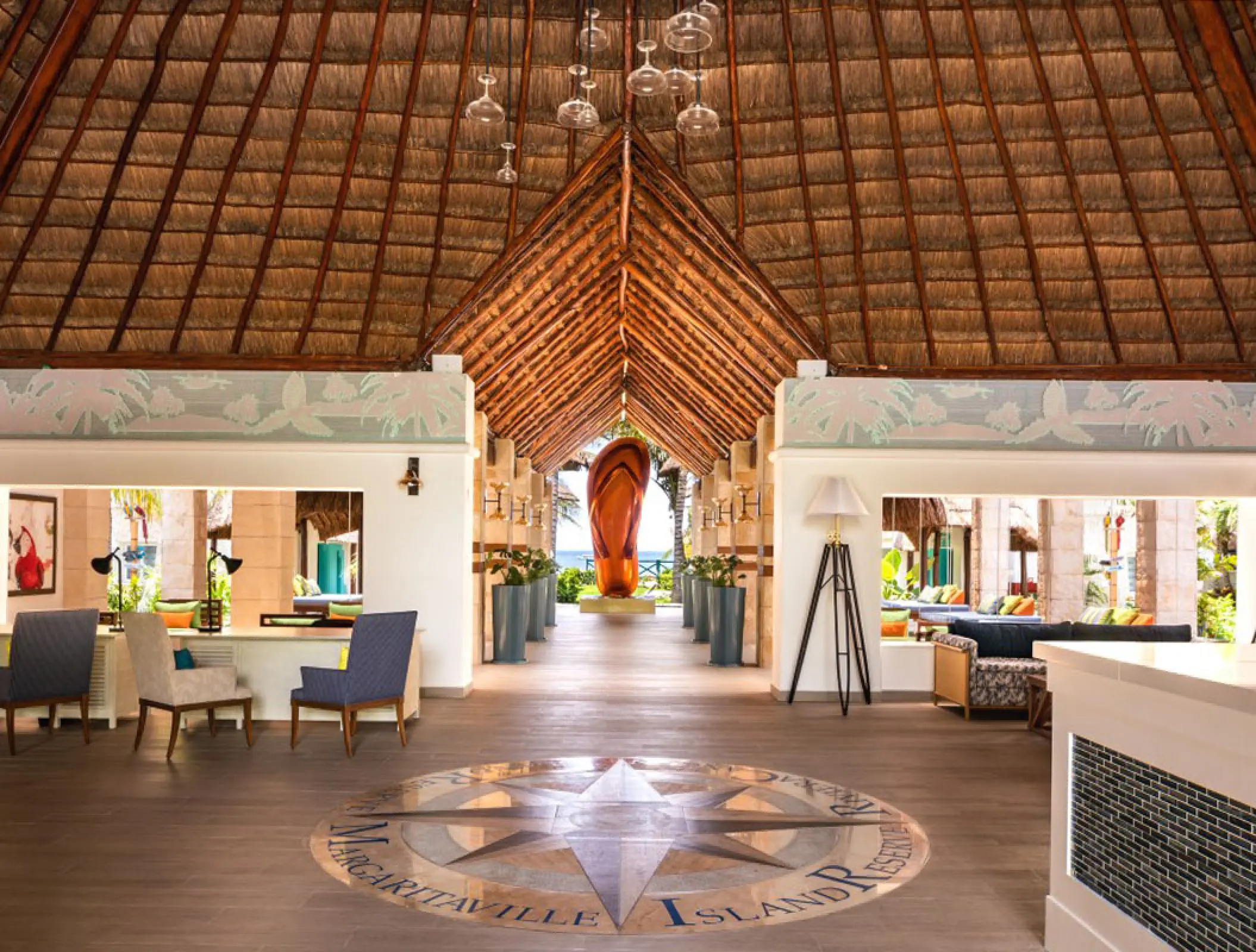 Margaritaville Island Reserve Riviera Cancun lobby with a thatched palapa roof and compass floor mosaic, Cancun