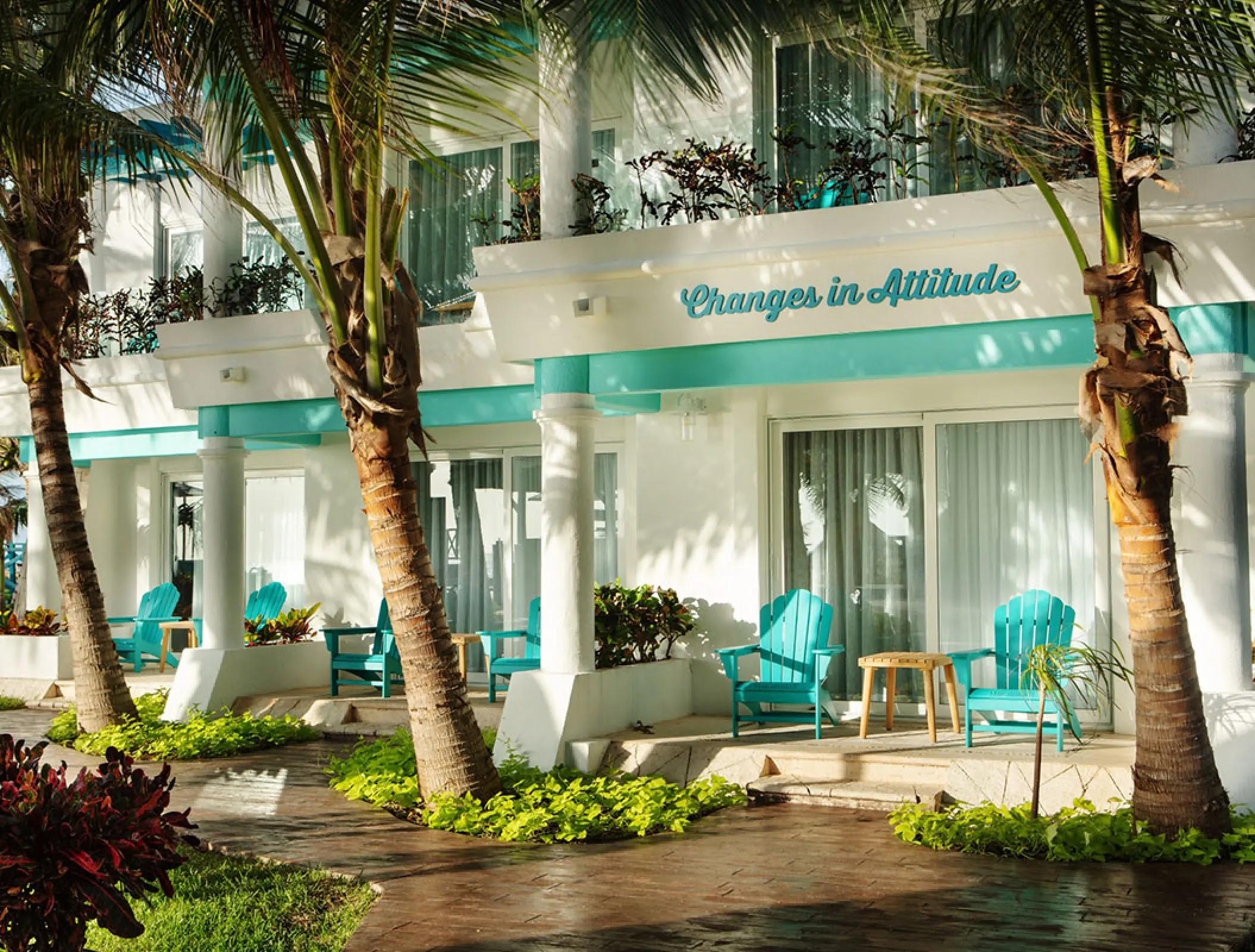 Ground floor terrace with turquoise chairs at Margaritaville Island Reserve Riviera Cancun, Cancun