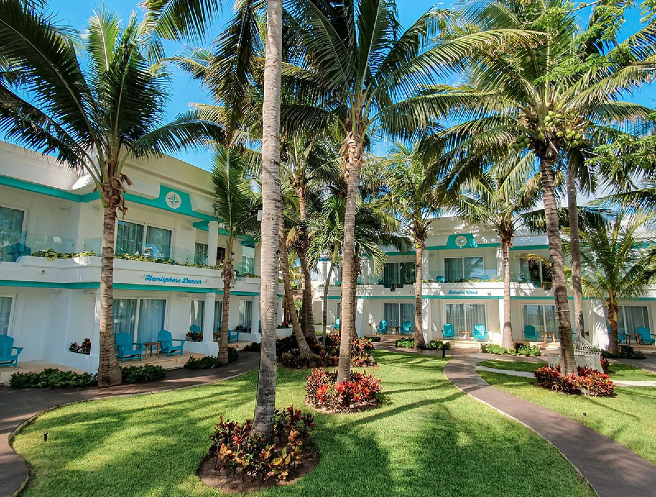 Palm tree lined courtyard and suites at Margaritaville Island Reserve Riviera Cancun