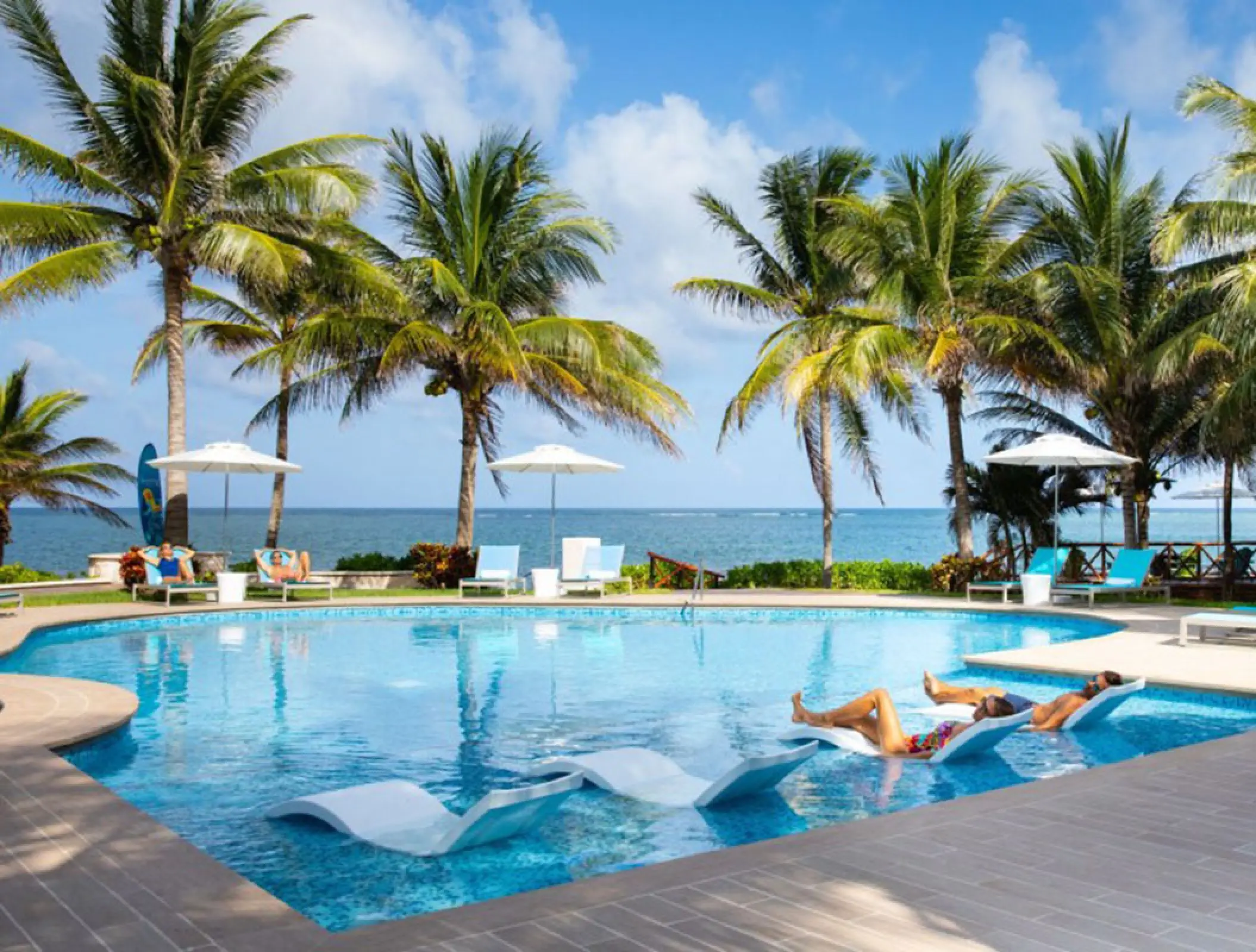 Margaritaville Island Reserve Riviera Cancun swimming pool with loungers and palm trees, Cancun