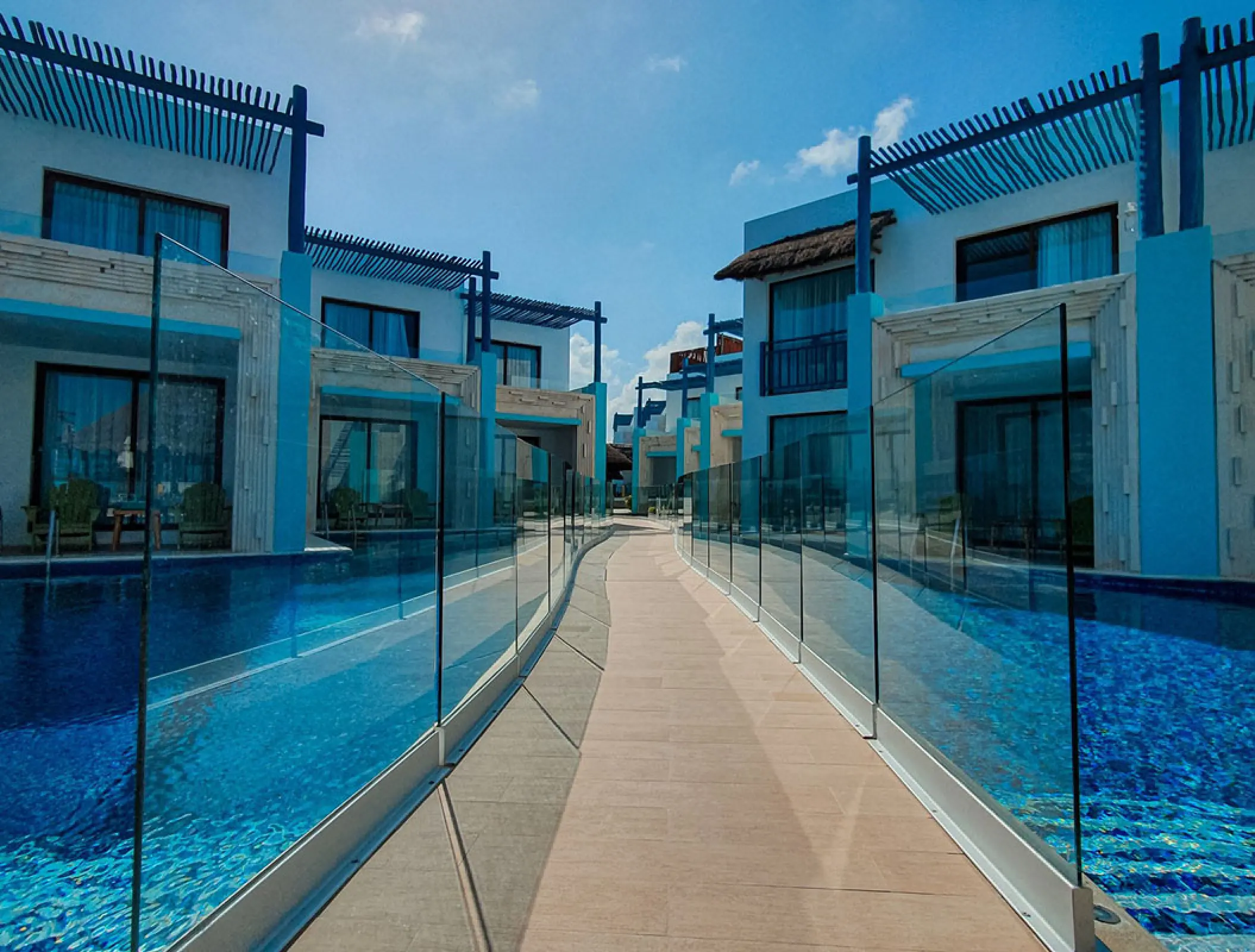 Swim-up suites and blue tiered buildings at Margaritaville Island Reserve Riviera Cancun, Cancun