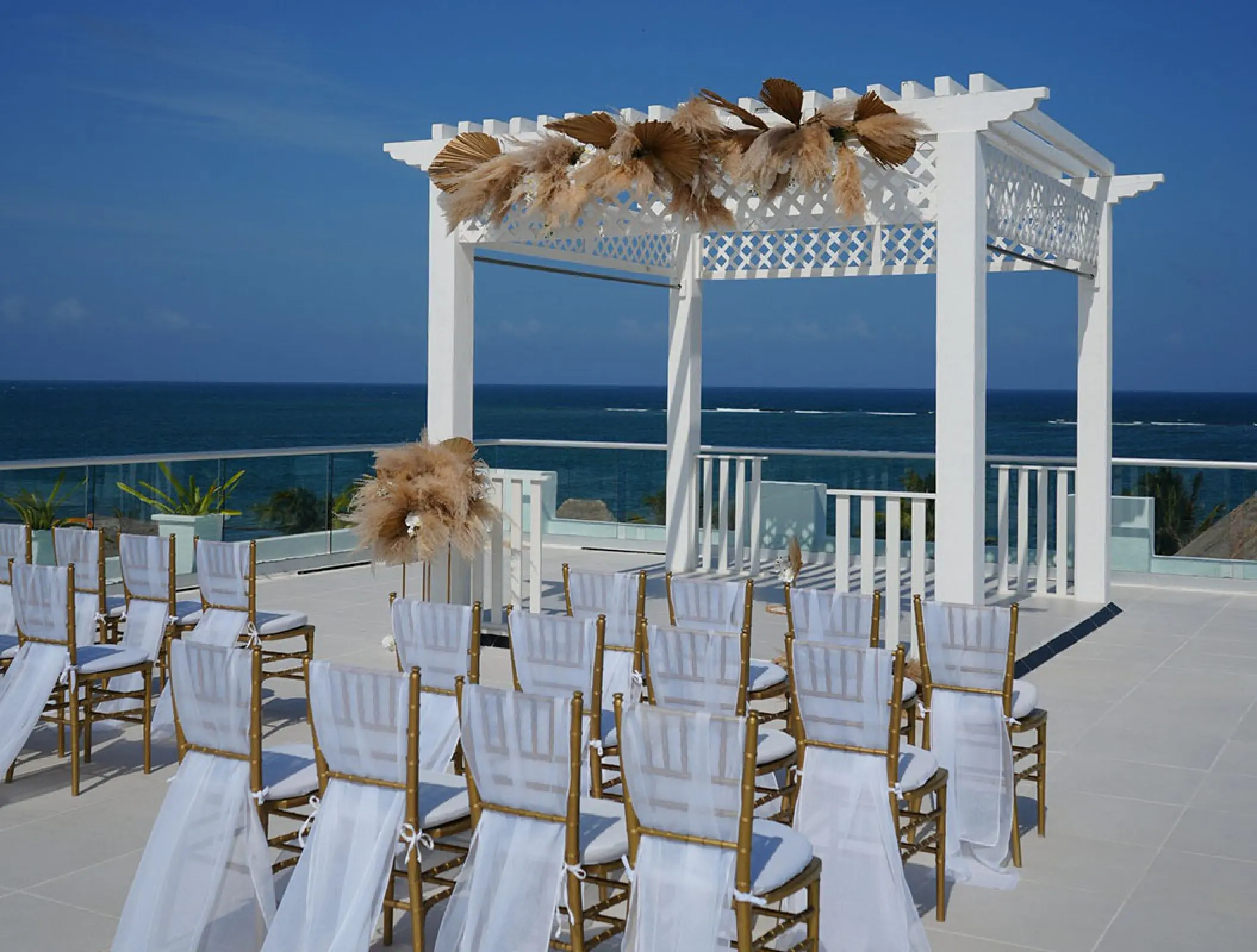 Rooftop wedding ceremony under a white pergola at Margaritaville Island Reserve Riviera Cancun, Cancun