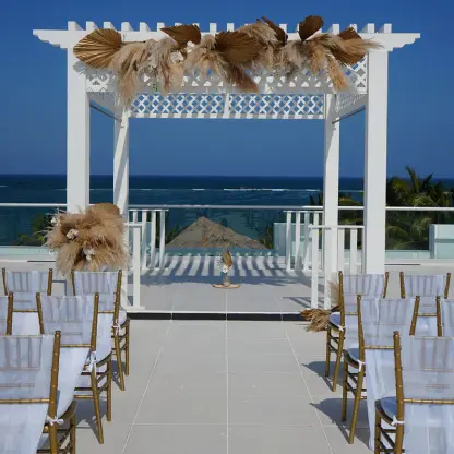 Rooftop wedding ceremony venue with pampas grass decor at Margaritaville Island Reserve Riviera Cancun, Cancun